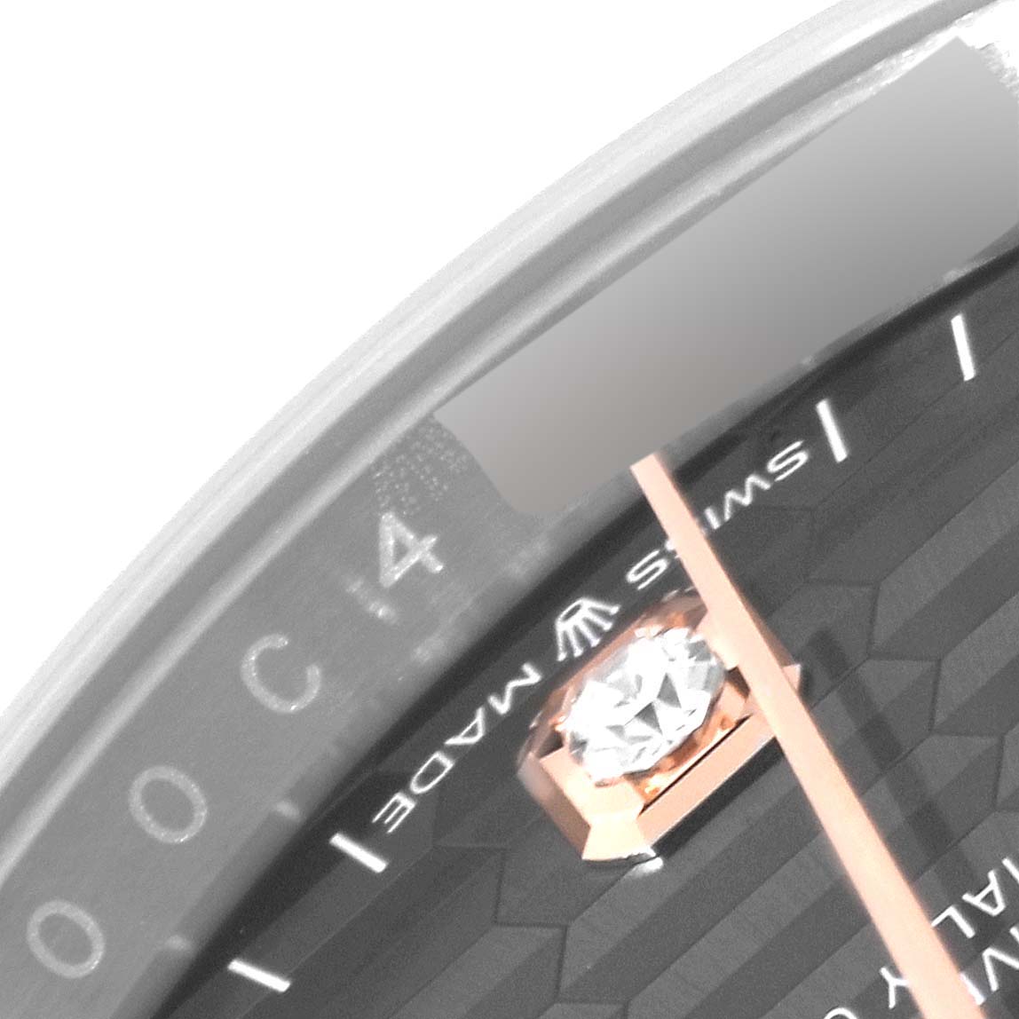 This close-up image of a Rolex Datejust 126231 Men's Steel and Gold (two tone) Grey Dial 126231 Men's Steel and Gold (two tone) Grey Dial model watch shows part of the dial near the '4' marker and the text "Swiss Made."