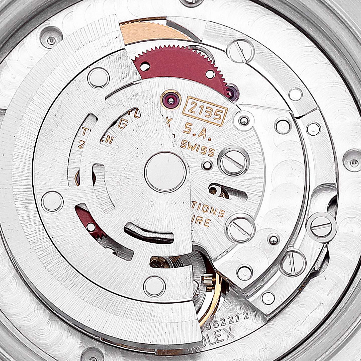 This image shows an up-close view of the inner mechanical movement of a Mid-Size Rolex watch, highlighting gears and rotors.