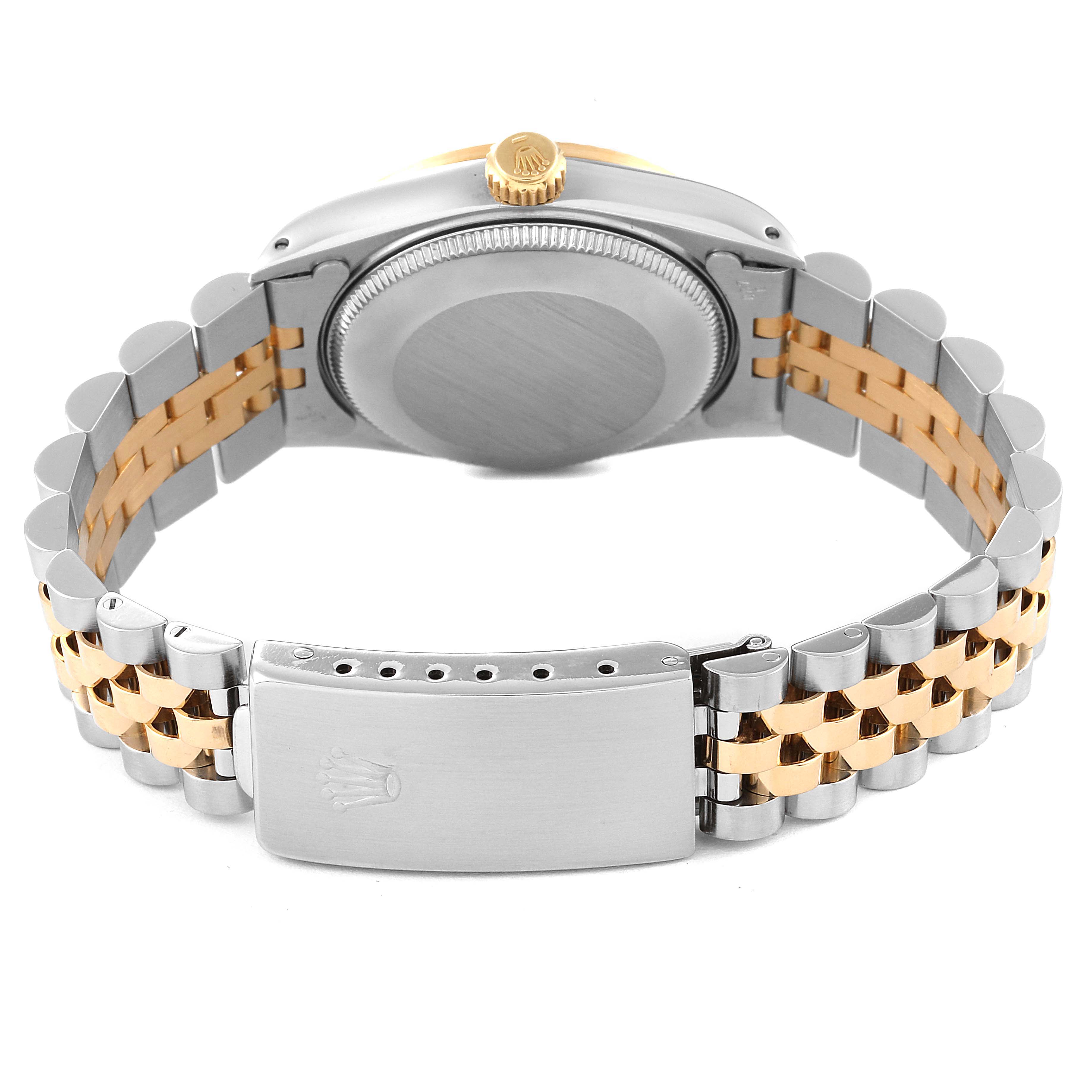 The image shows the back view and clasp of a Mid-Size Rolex watch, highlighting its two-tone bracelet and the case back.