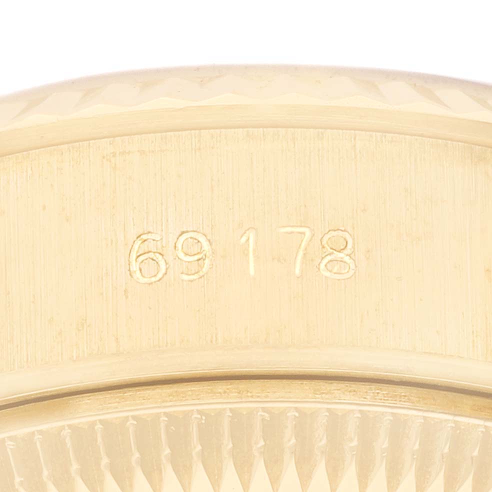 This close-up image shows the side of the Rolex President 69178 Women
s Yellow Gold Champagne Dial 69178 Women
s Yellow Gold Champagne Dial model watch, specifically the engraved model number "69178."