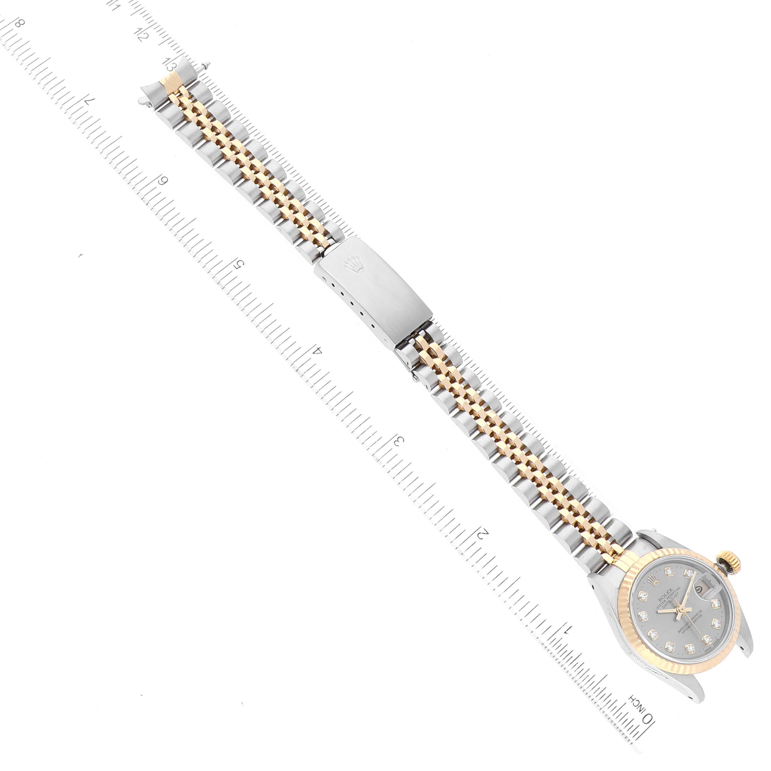 The image shows a Rolex Datejust 69173G Women's Steel and Gold (two tone) Grey Dial 69173G Women's Steel and Gold (two tone) Grey Dial watch laid flat, displaying the band and face next to a ruler for sizing reference.