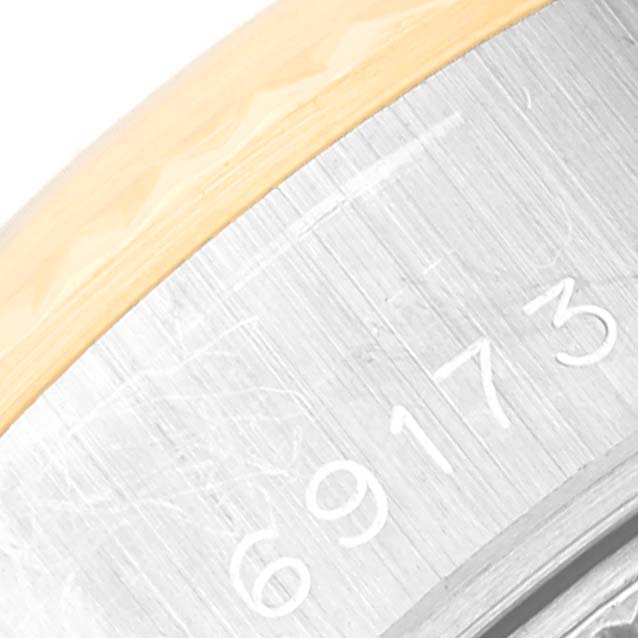 This image shows a close-up of the side of a Rolex Datejust 69173G Women's Steel and Gold (two tone) Grey Dial 69173G Women's Steel and Gold (two tone) Grey Dial watch revealing part of its model number engraved.