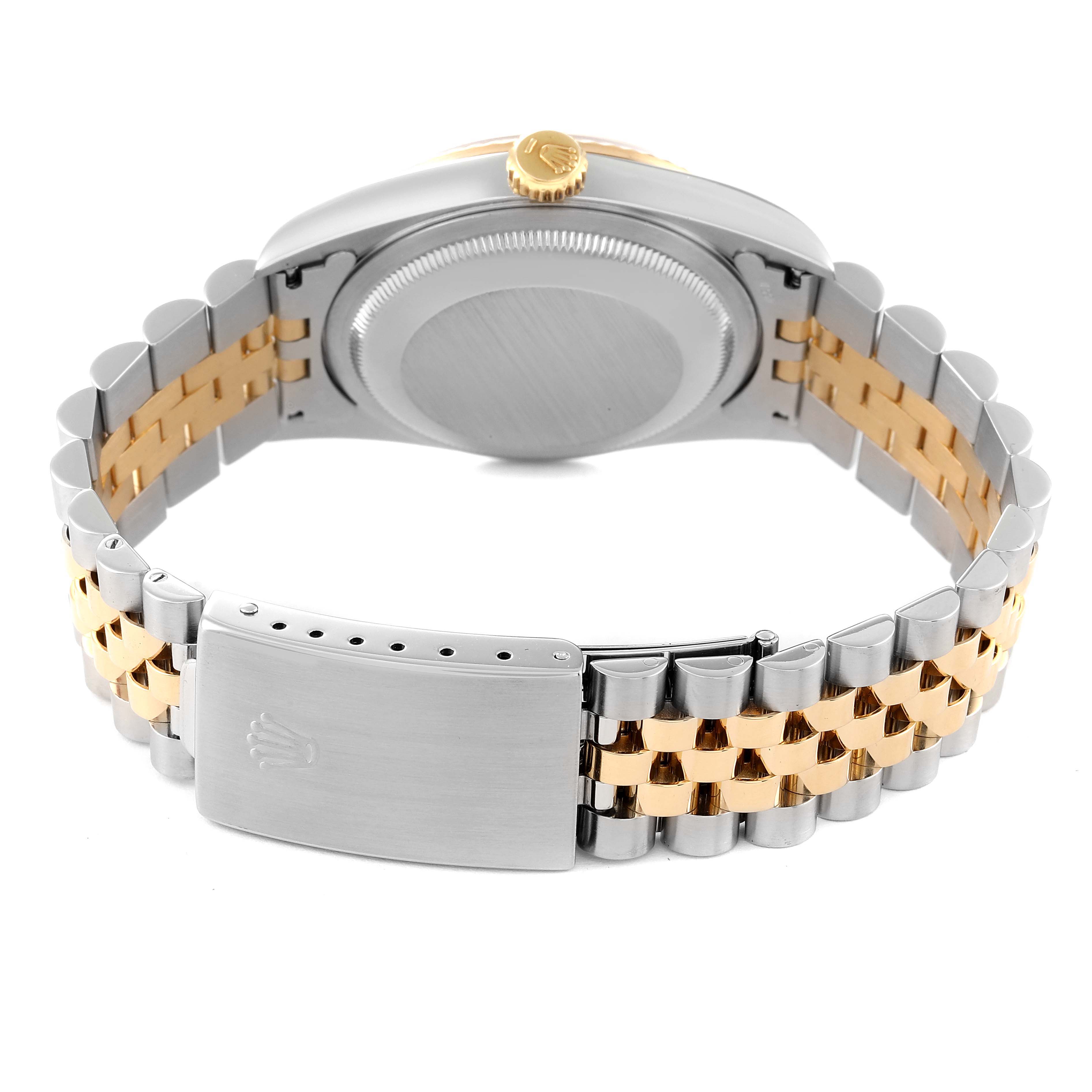 The image shows the backside of a Rolex Datejust 16233 Men's Steel and Gold (two tone) Champagne Dial 16233 Men's Steel and Gold (two tone) Champagne Dial model, highlighting its two-tone bracelet, clasp, and case back.