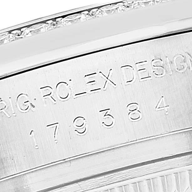 This close-up image shows the engraved model number and part of the bezel on a Rolex Datejust 179384 Women's Stainless Steel Pink Dial 179384 Women's Stainless Steel Pink Dial watch.