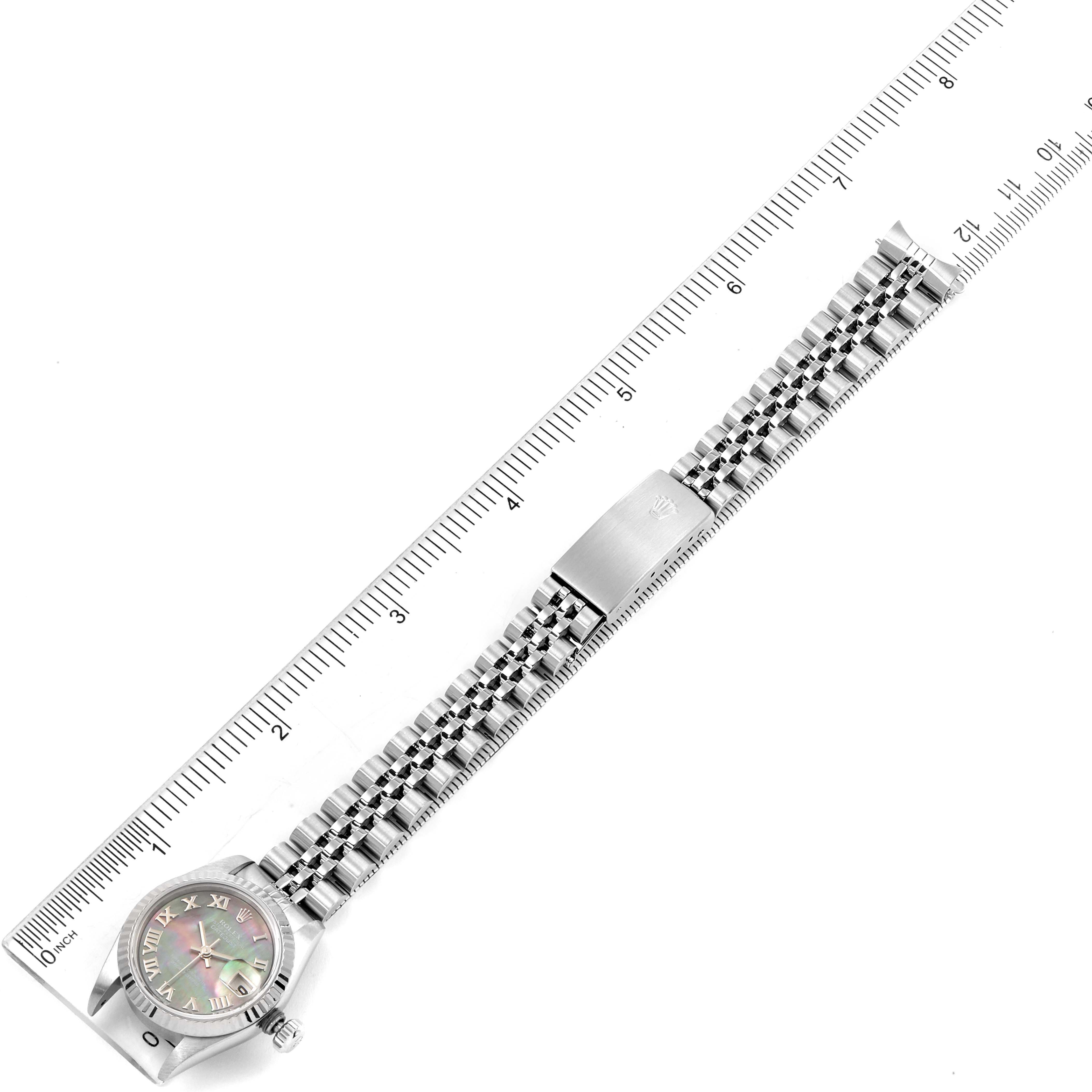 The image shows a Rolex Datejust 69174 Women's Stainless Steel Mother of Pearl Dial 69174 Women's Stainless Steel Mother of Pearl Dial watch laid flat with a ruler beside it, showcasing the bracelet and dial from a top-down angle.