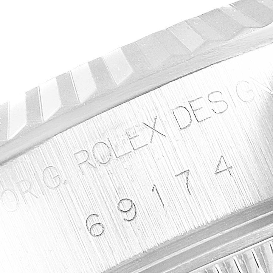This image shows a close-up view of the engraved model number (69174) and part of the fluted bezel on a Rolex Datejust 69174 Women's Stainless Steel Mother of Pearl Dial 69174 Women's Stainless Steel Mother of Pearl Dial watch.