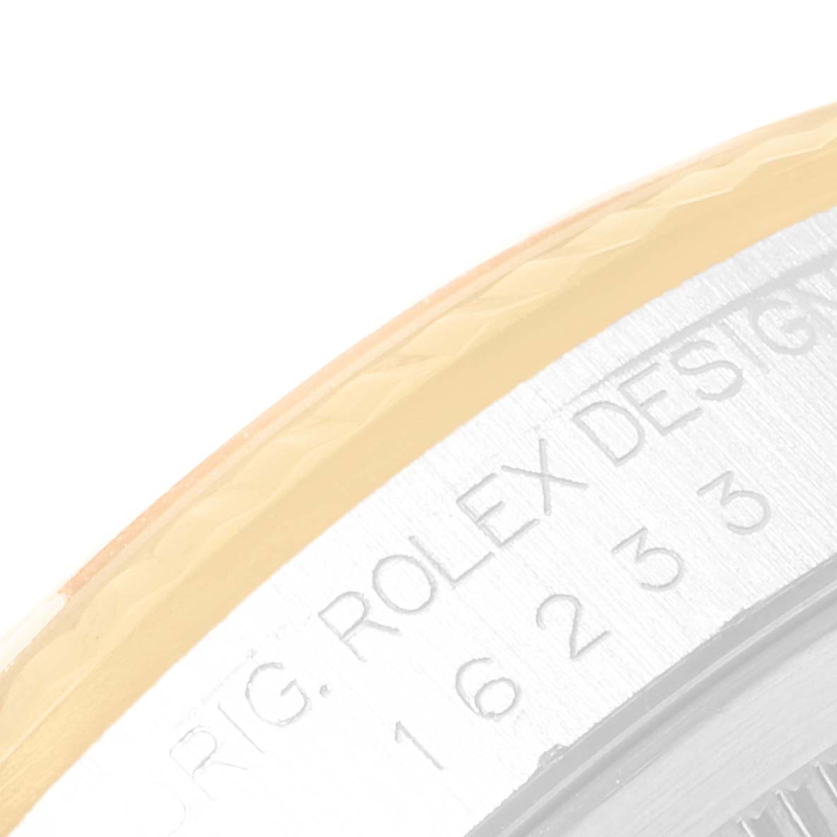 The image shows an extreme close-up of the side of a Rolex Datejust 16233 Men's Steel and Gold (two tone) Black Dial 16233 Men's Steel and Gold (two tone) Black Dial model watch, highlighting the engraved text and part of the bezel.