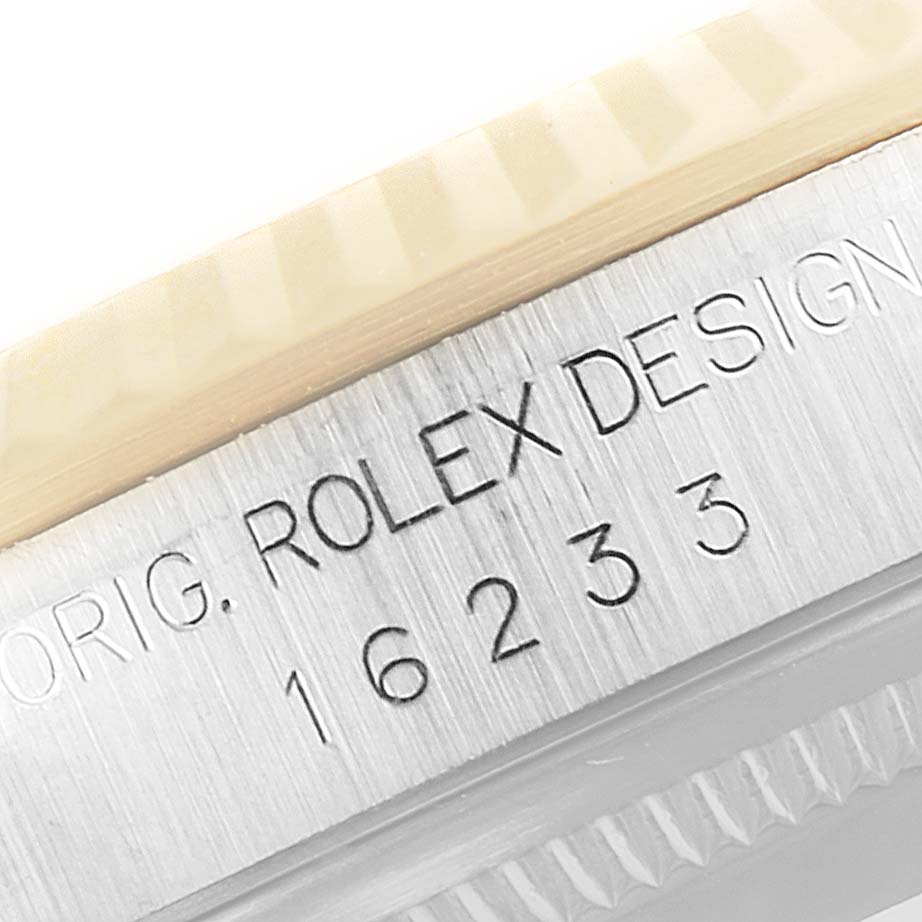 This image shows a close-up of the engraved casing on the Rolex Datejust 16233 Men's Steel and Gold (two tone) Silver Dial 16233 Men's Steel and Gold (two tone) Silver Dial model, highlighting the serial number and "Rolex Design" text.