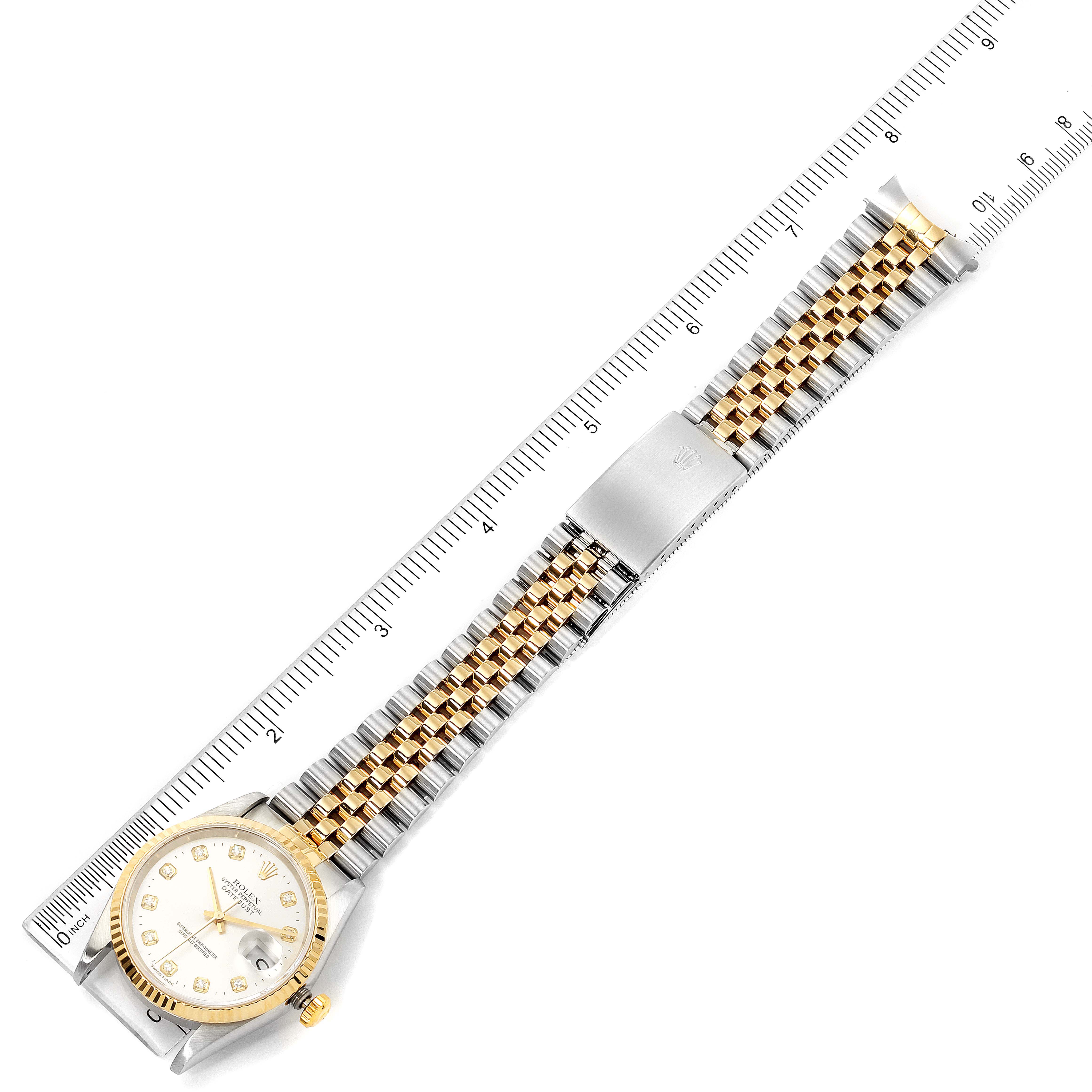 The image shows a Rolex Datejust 16233 Men's Steel and Gold (two tone) Silver Dial 16233 Men's Steel and Gold (two tone) Silver Dial watch, including the face and Jubilee bracelet, measured against a ruler, seen from a top-down angle.