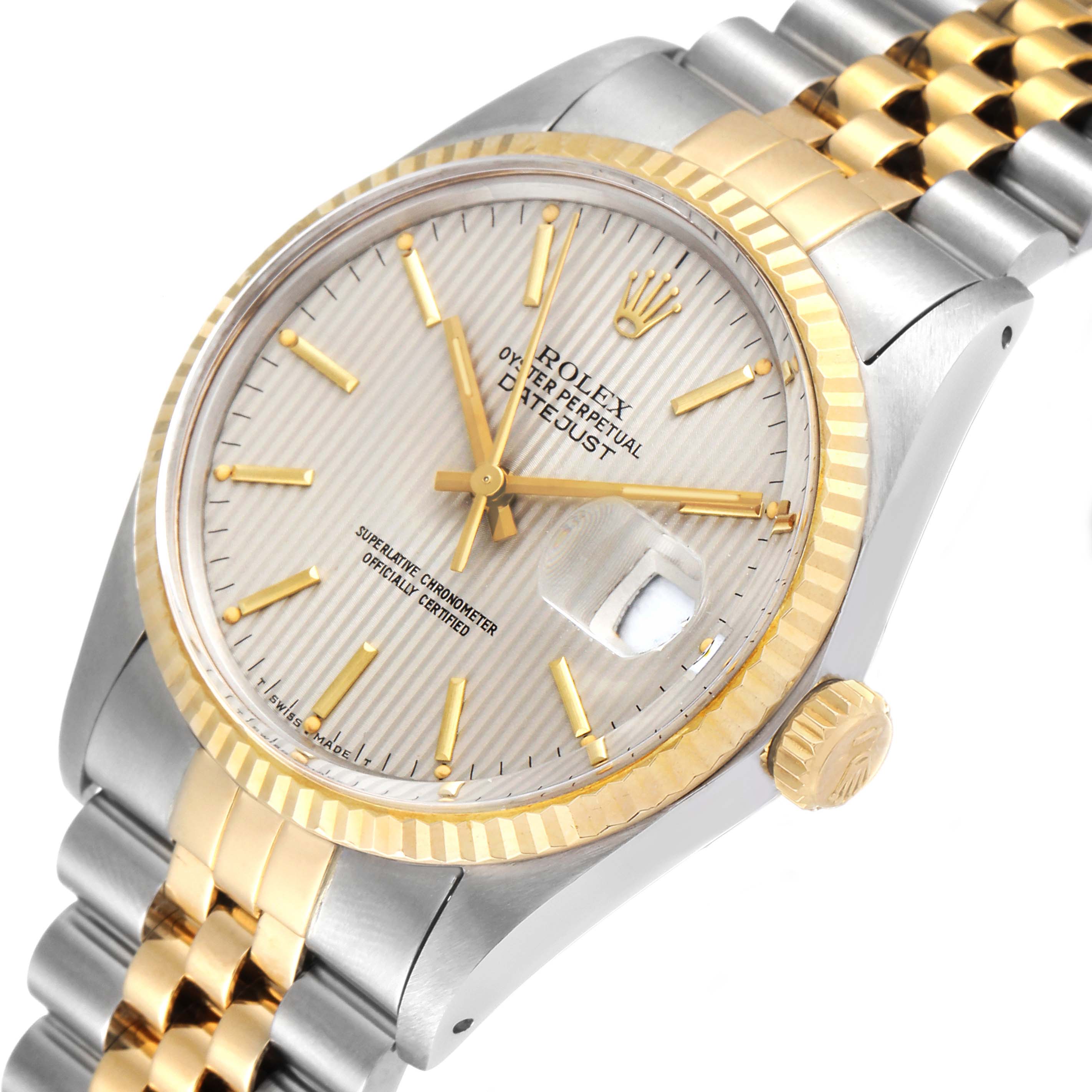 The image shows a close-up angle of a Rolex Datejust 16013 Men's Steel and Gold (two tone) Silver Dial 16013 Men's Steel and Gold (two tone) Silver Dial watch, highlighting its fluted bezel, crown, and two-tone bracelet.