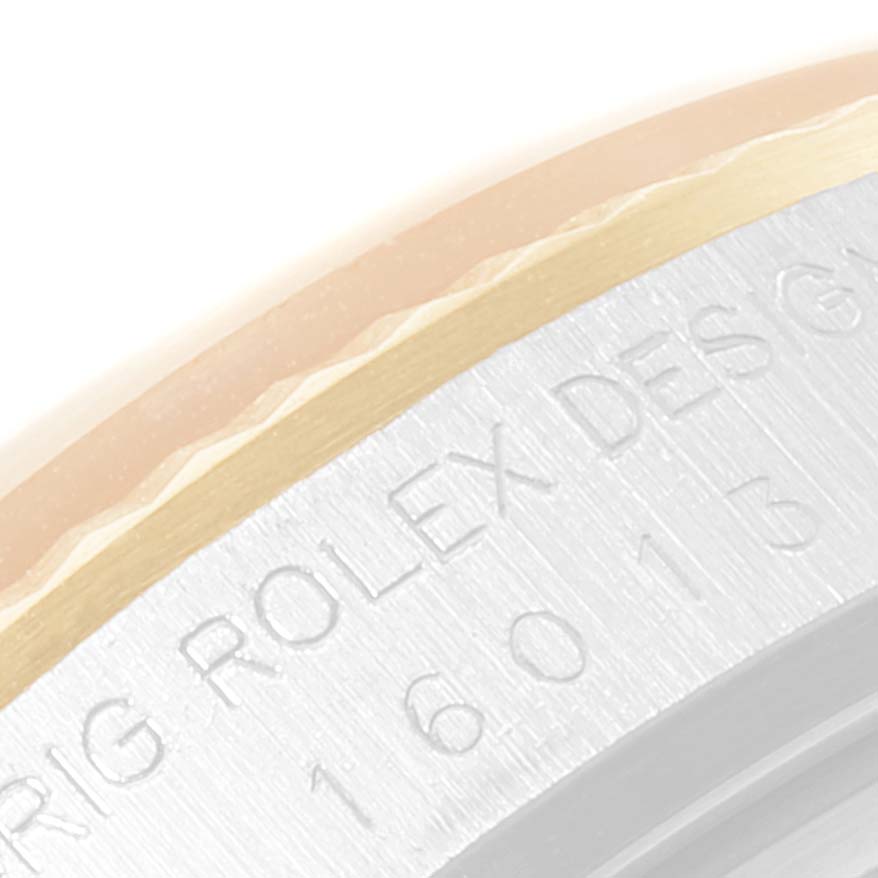 This close-up image shows a partial view of the bezel and case with inscriptions on a Rolex Datejust 16013 Men's Steel and Gold (two tone) Silver Dial 16013 Men's Steel and Gold (two tone) Silver Dial watch.