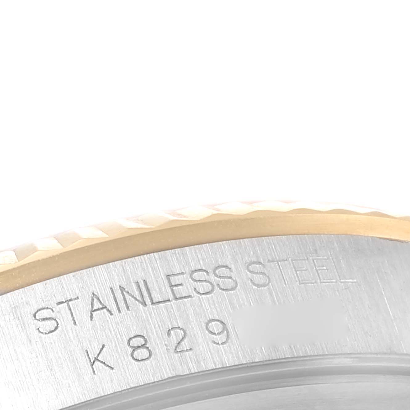 This close-up image shows a portion of the bezel and engraving on the side of a Rolex Datejust 16233 Men's Steel and Gold (two tone) White Dial 16233 Men's Steel and Gold (two tone) White Dial watch, highlighting "STAINLESS STEEL."
