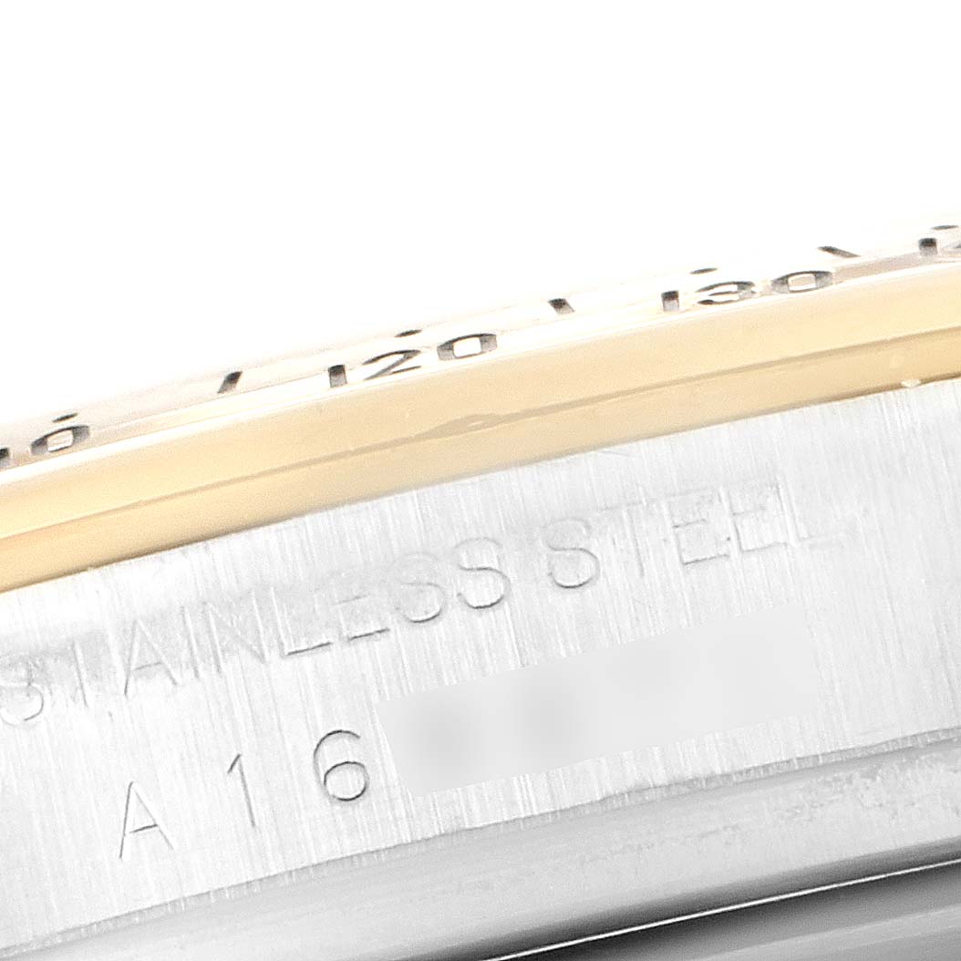This close-up image shows the side of a Rolex Daytona 16523 Men's Steel and Gold (two tone) White Dial 16523 Men's Steel and Gold (two tone) White Dial watch with "STAINLESS STEEL" engraved.