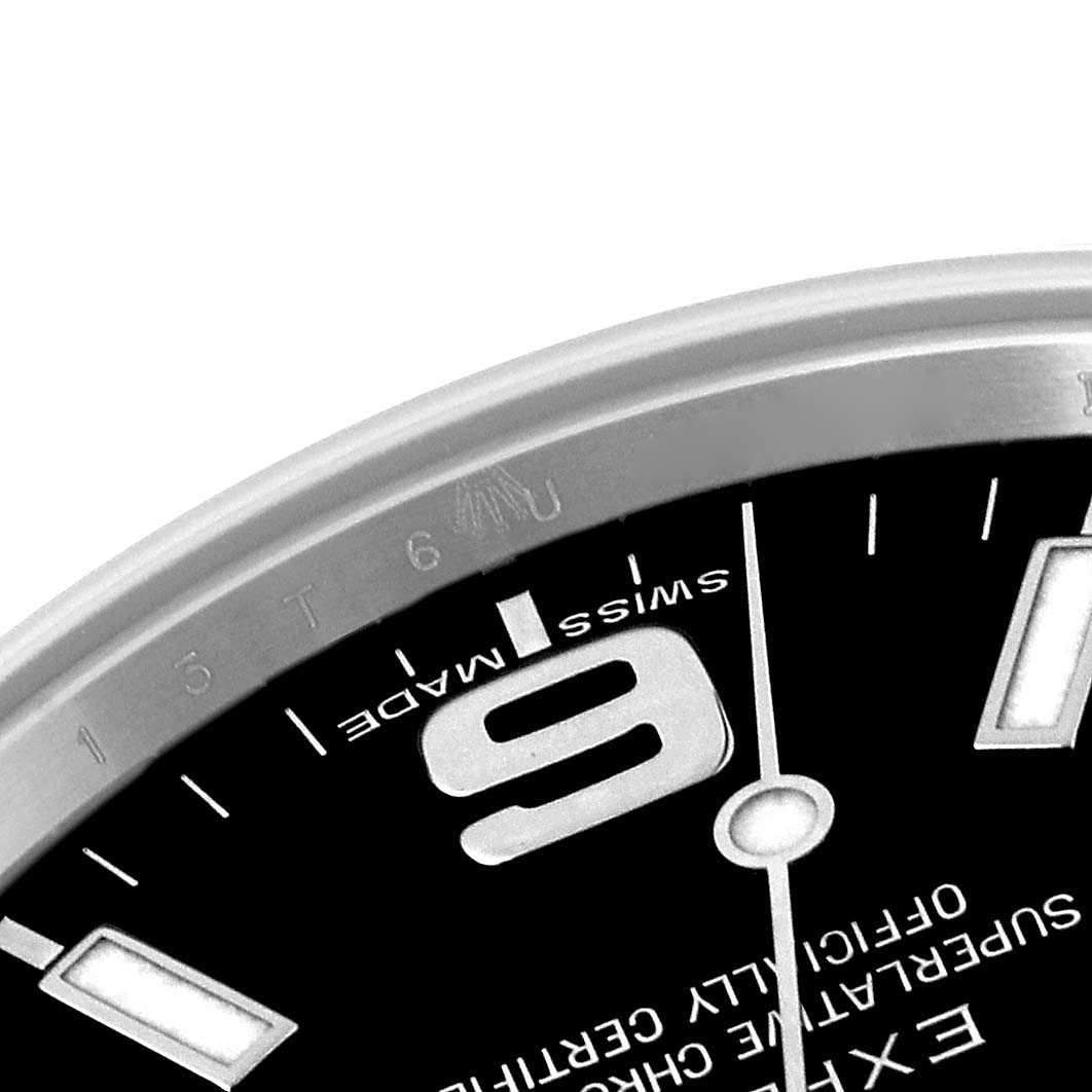 This image shows a close-up of the dial and part of the bezel of a Rolex Explorer 214270 Men's Stainless Steel Black Dial 214270 Men's Stainless Steel Black Dial watch.