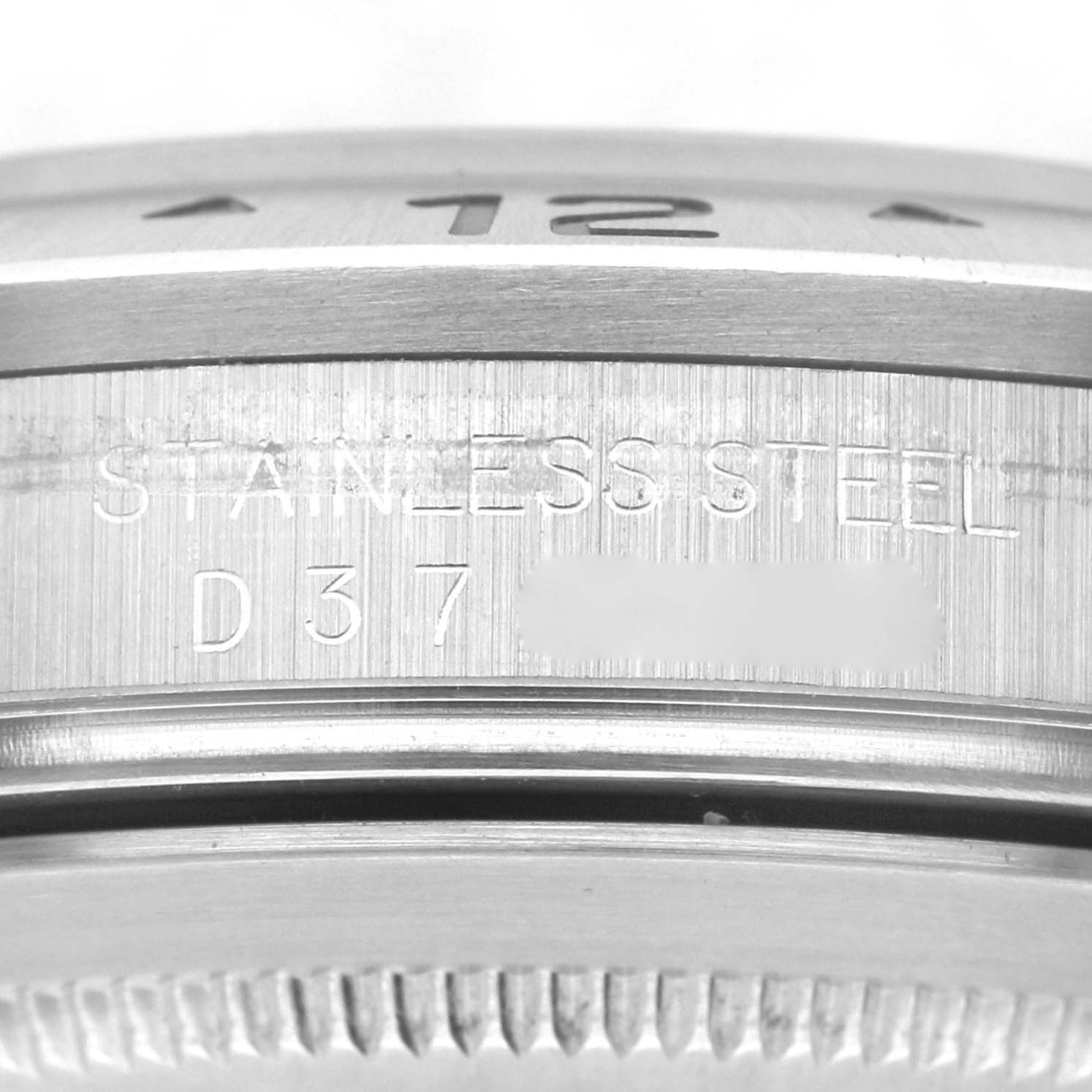 This image shows a close-up angle of the Rolex Explorer 16570 Men's Stainless Steel Black Dial 16570 Men's Stainless Steel Black Dial model, focusing on the case side with its serial number and "STAINLESS STEEL" engraving.