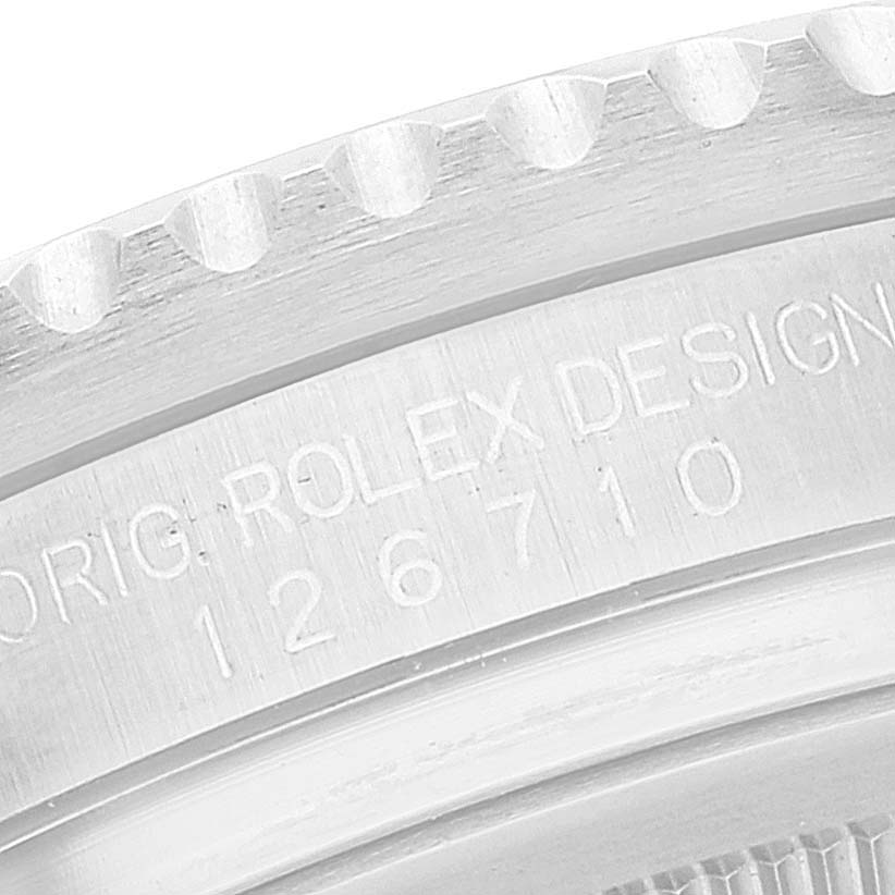 Close-up view of the engraved numbers and text on the side of a Rolex GMT-Master 126710 Men
s Stainless Steel Black Dial 126710 Men
s Stainless Steel Black Dial bezel.