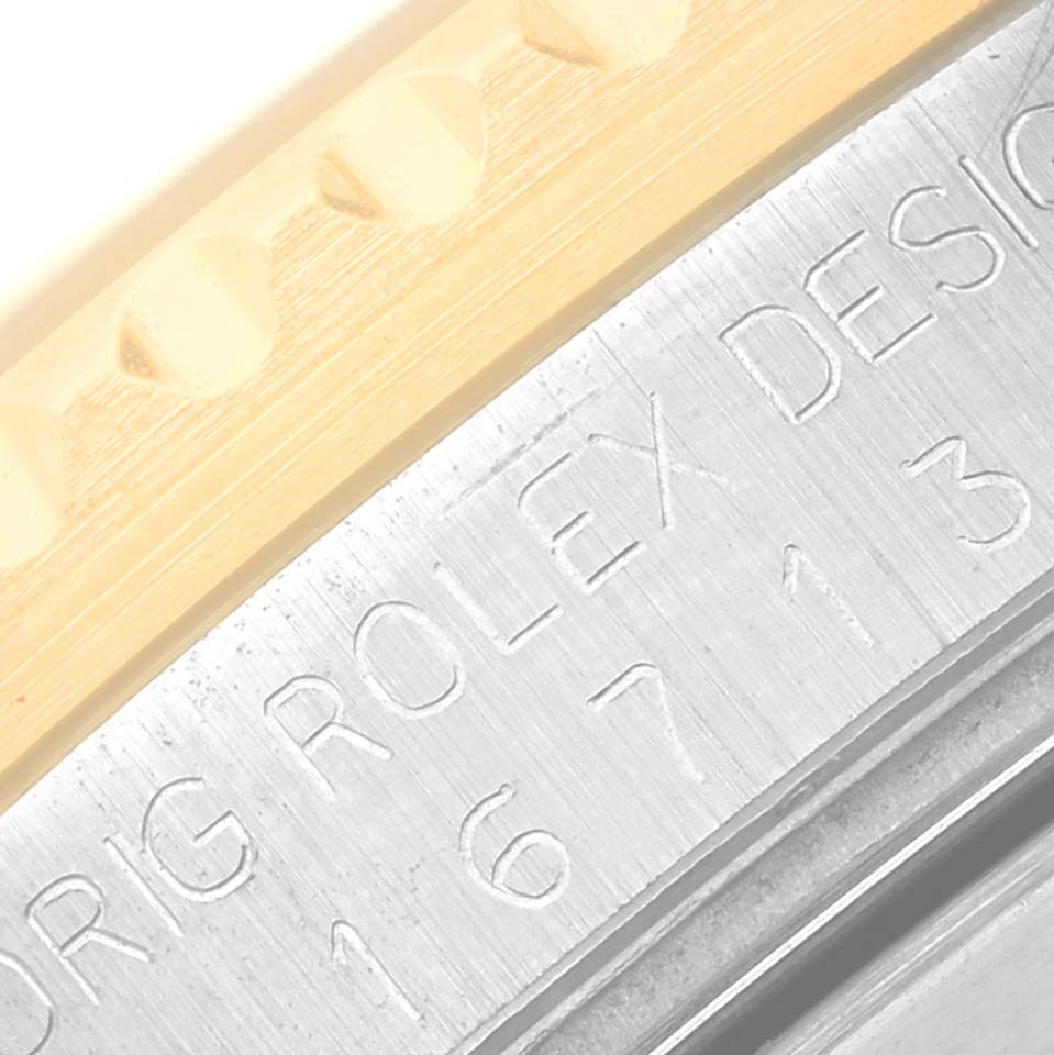 This close-up image shows the engraved model number and design stamp on the case of a Rolex GMT-Master 16713 Men's Steel and Gold (two tone) Black Dial 16713 Men's Steel and Gold (two tone) Black Dial watch.