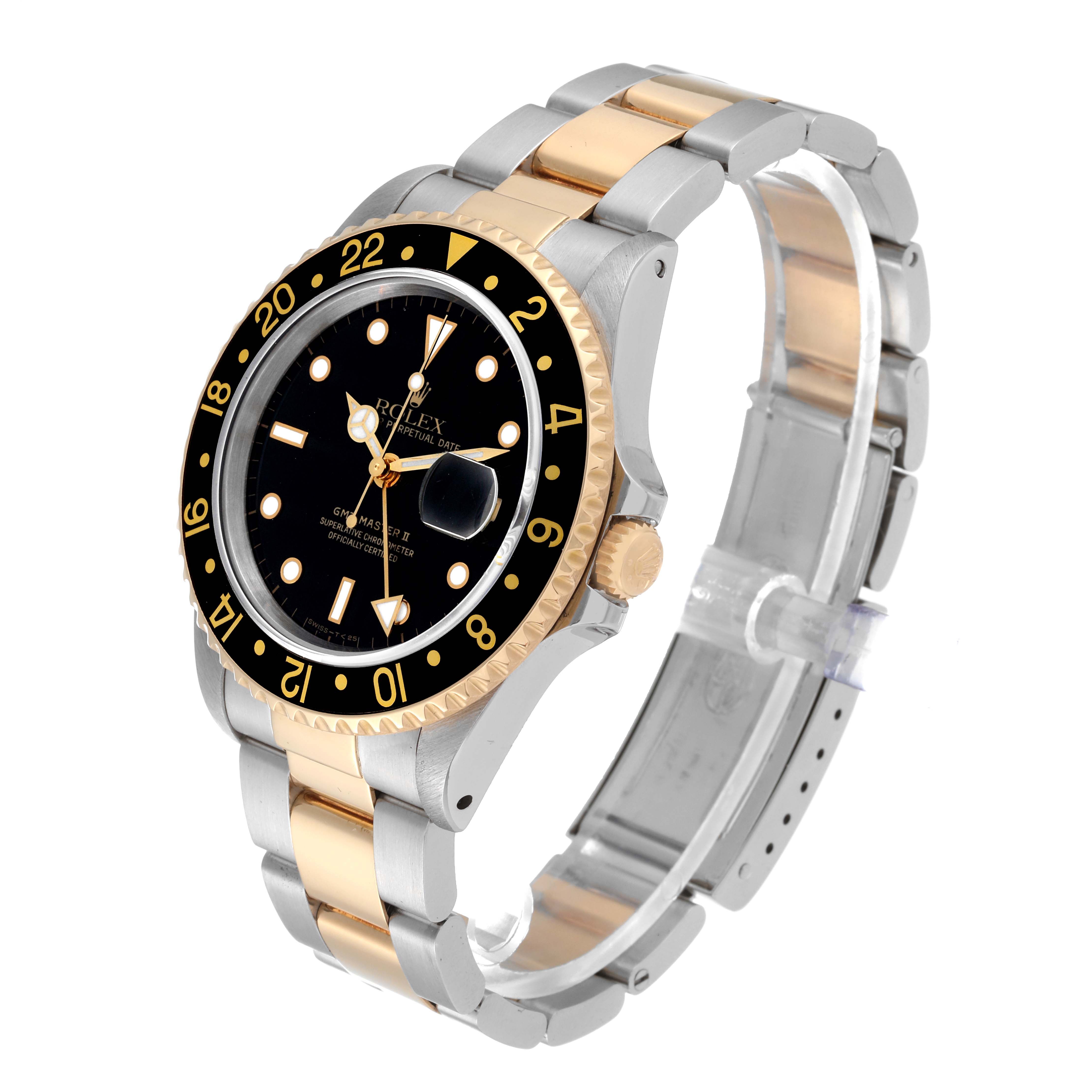 The Rolex GMT-Master 16713 Men's Steel and Gold (two tone) Black Dial 16713 Men's Steel and Gold (two tone) Black Dial watch is shown at a three-quarter angle, displaying the dial, bezel, and part of the two-tone bracelet.