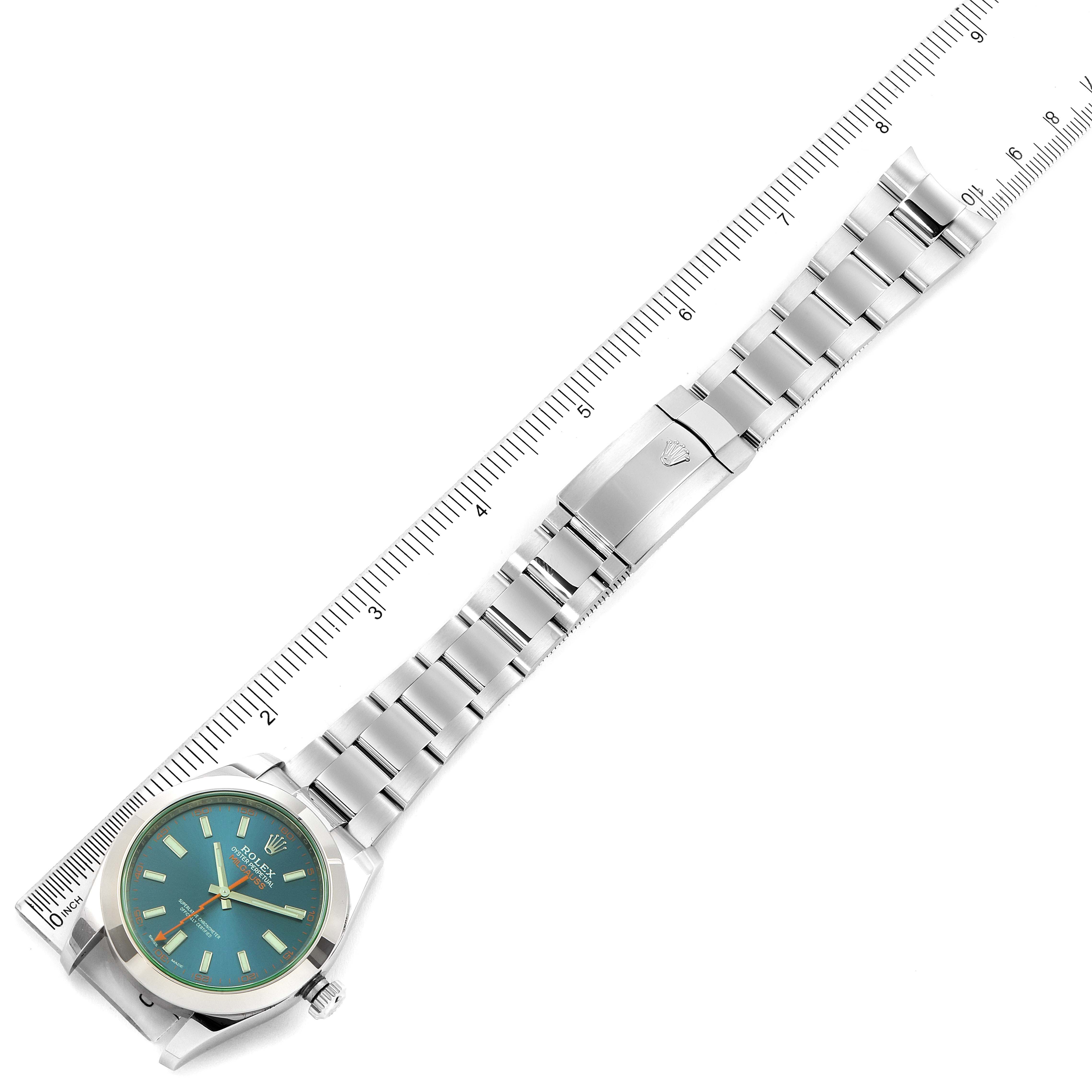 The image shows a full view of the Rolex Milgauss 116400GV Men
s Stainless Steel Blue Dial 116400GV Men
s Stainless Steel Blue Dial watch positioned diagonally, along with a measurement ruler.