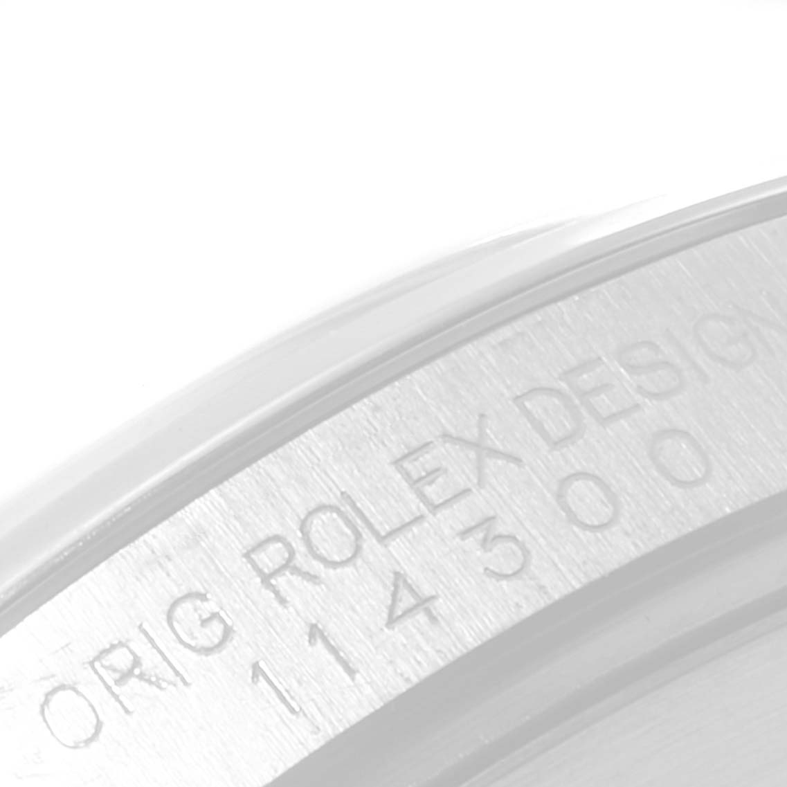 The image shows a close-up of the side of the bezel with the Rolex brand and model number engraved on the Oyster Perpetual watch.