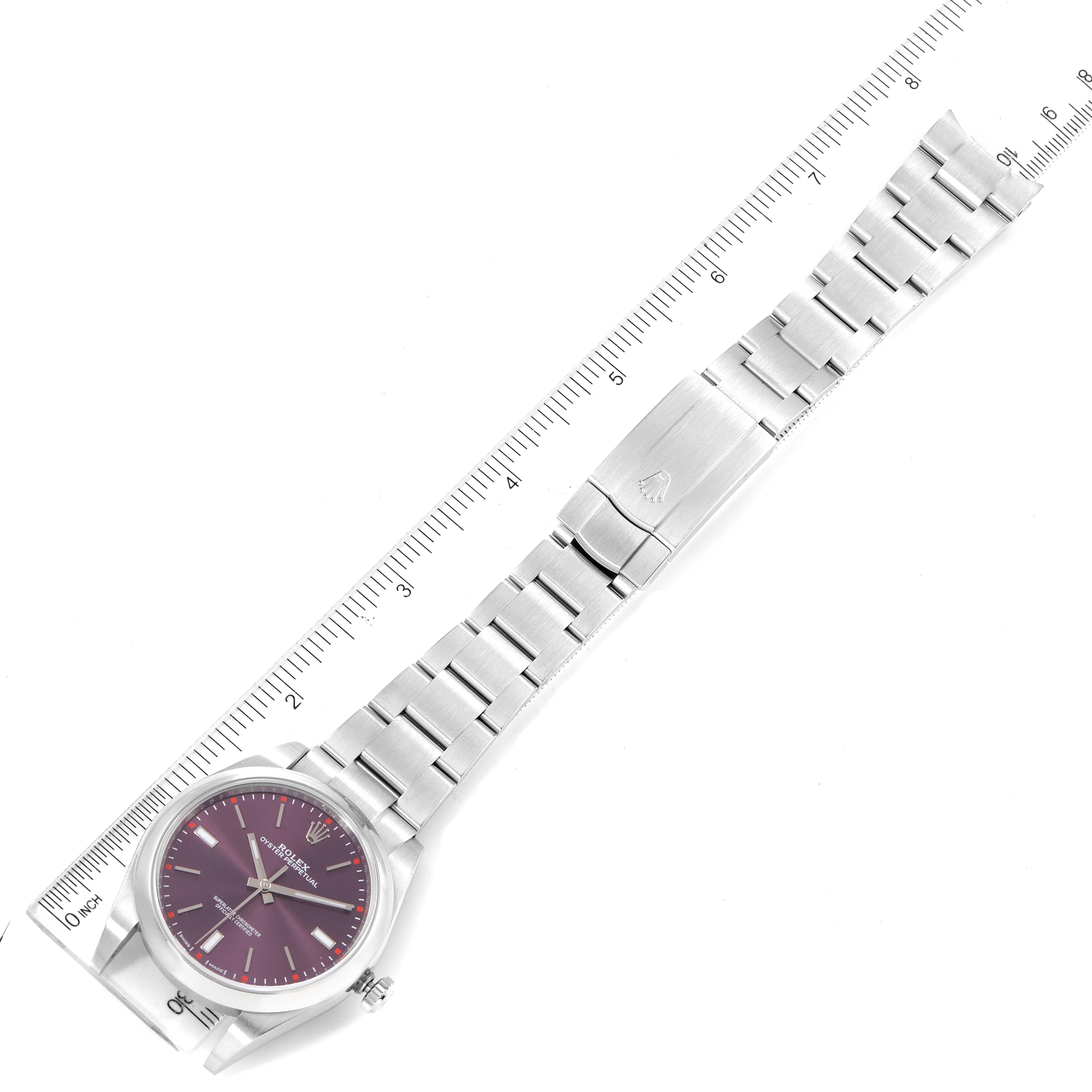 The Rolex Oyster Perpetual 114300 Men's Stainless Steel Burgundy Dial 114300 Men's Stainless Steel Burgundy Dial watch is shown from a top-down angle, displaying the full length of the watch including the dial, case, and bracelet.