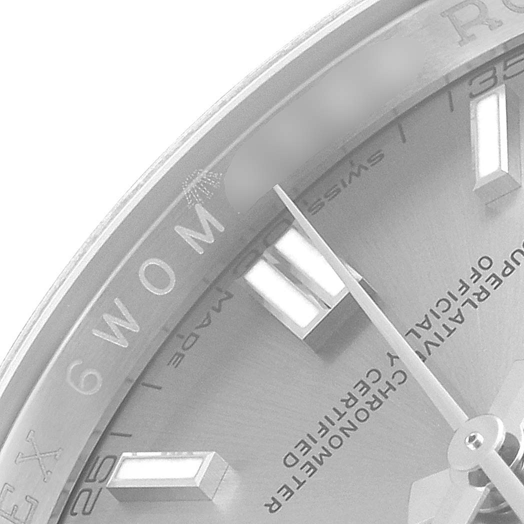 The image shows a close-up of the dial of a Rolex Oyster Perpetual 116000 Men
s Stainless Steel Grey Dial 116000 Men
s Stainless Steel Grey Dial watch, highlighting the markers and hands.