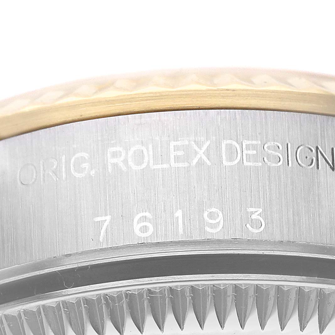 The image shows a close-up angle of the serial number and part of the bezel of a Rolex Datejust 76193 Women's Steel and Gold (two tone) Silver Dial 76193 Women's Steel and Gold (two tone) Silver Dial watch.