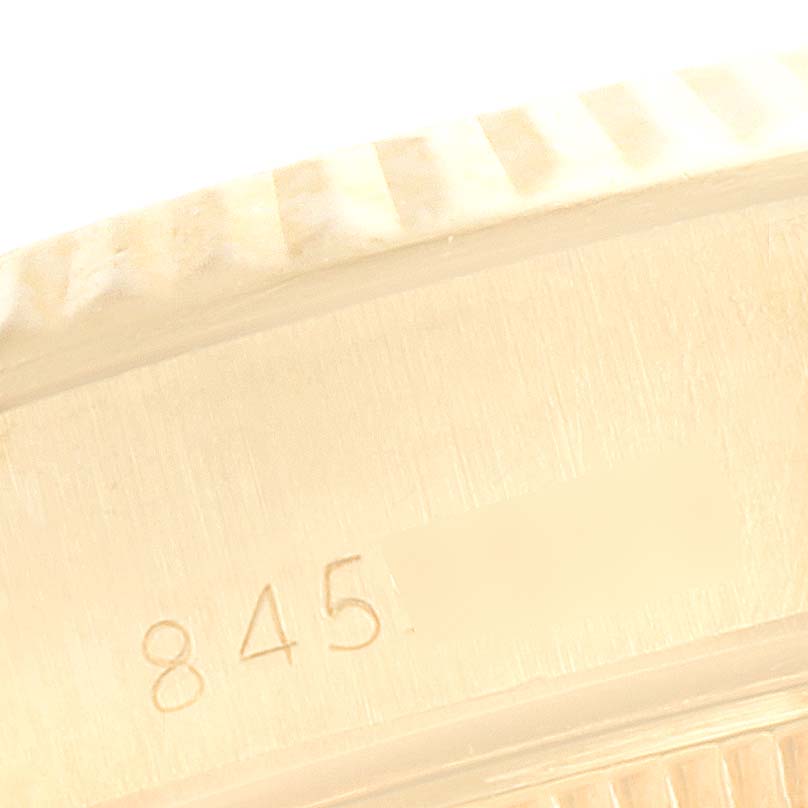This close-up image shows part of the bezel and engraved serial number on a Rolex President 69178 Women's Yellow Gold Champagne Dial 69178 Women's Yellow Gold Champagne Dial model watch.