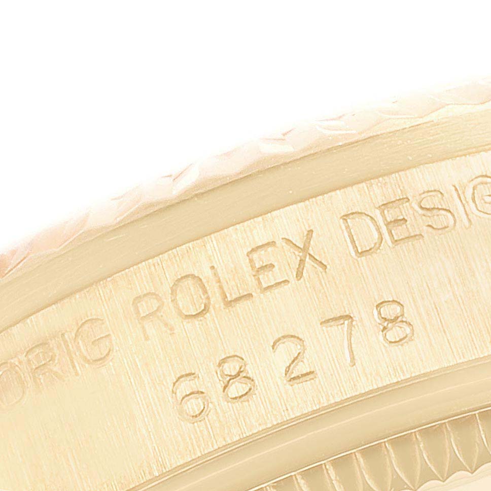 The image shows a close-up of the side of a Rolex President 68278 Women's Yellow Gold Champagne Dial 68278 Women's Yellow Gold Champagne Dial model watch, highlighting the engraved serial number and brand name.