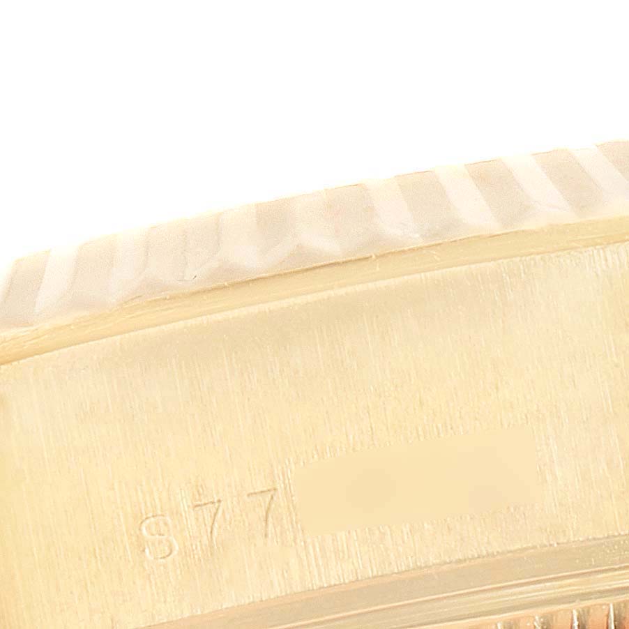 This is a close-up of the side of the bezel and case of a Rolex President 69178 Women
s Yellow Gold Champagne Dial 69178 Women
s Yellow Gold Champagne Dial model watch, showing part of the model number engraved.