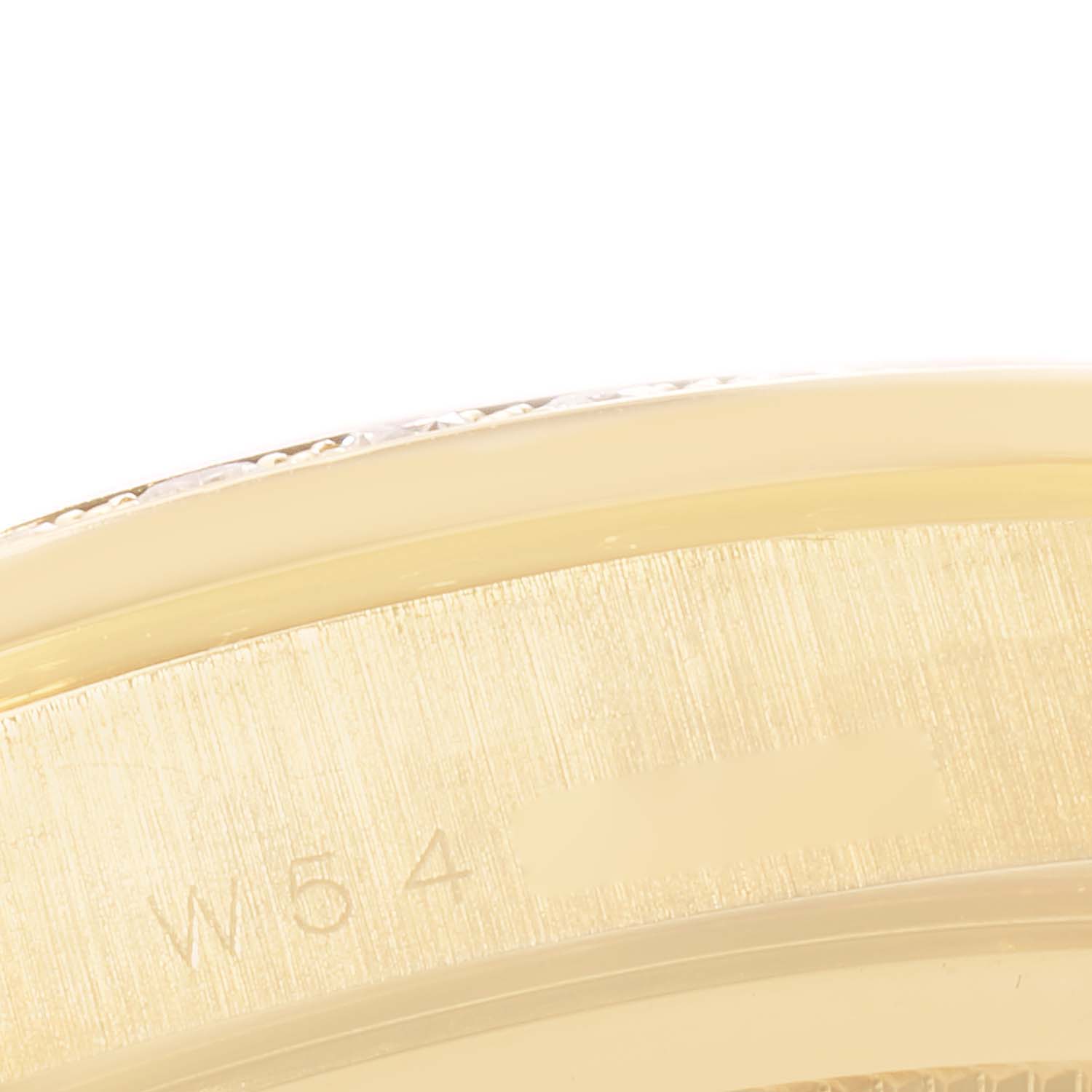 The image shows a close-up of the edge and part of the caseback of a Rolex President 18348 Men
s Yellow Gold Champagne Dial 18348 Men
s Yellow Gold Champagne Dial model watch.