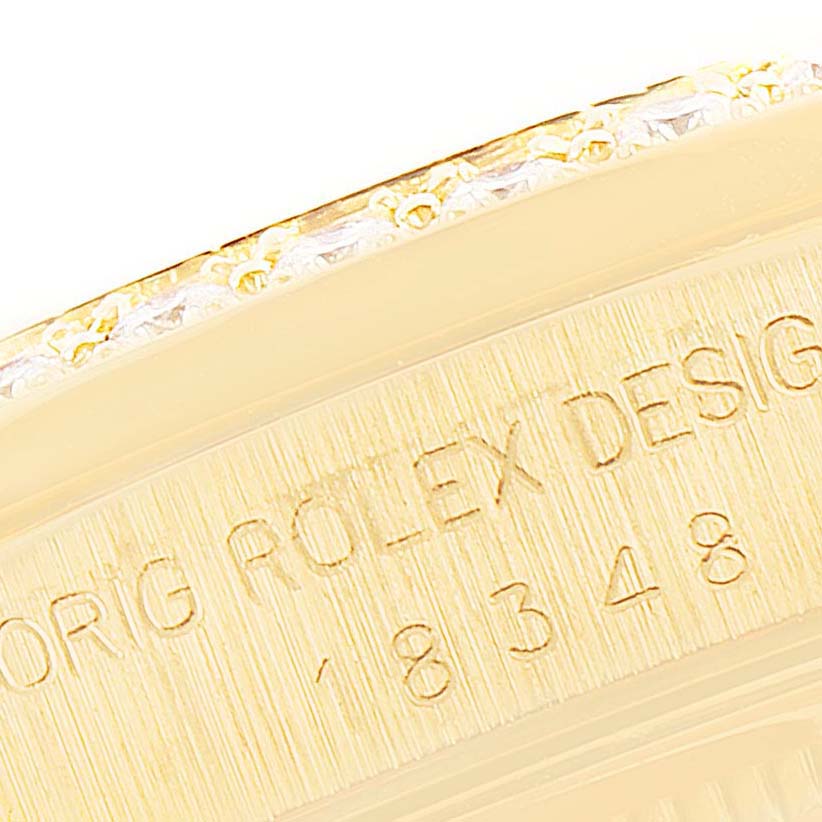 This close-up image shows the side engraving and part of the bezel of a Rolex President 18348 Men
s Yellow Gold Champagne Dial 18348 Men
s Yellow Gold Champagne Dial watch.