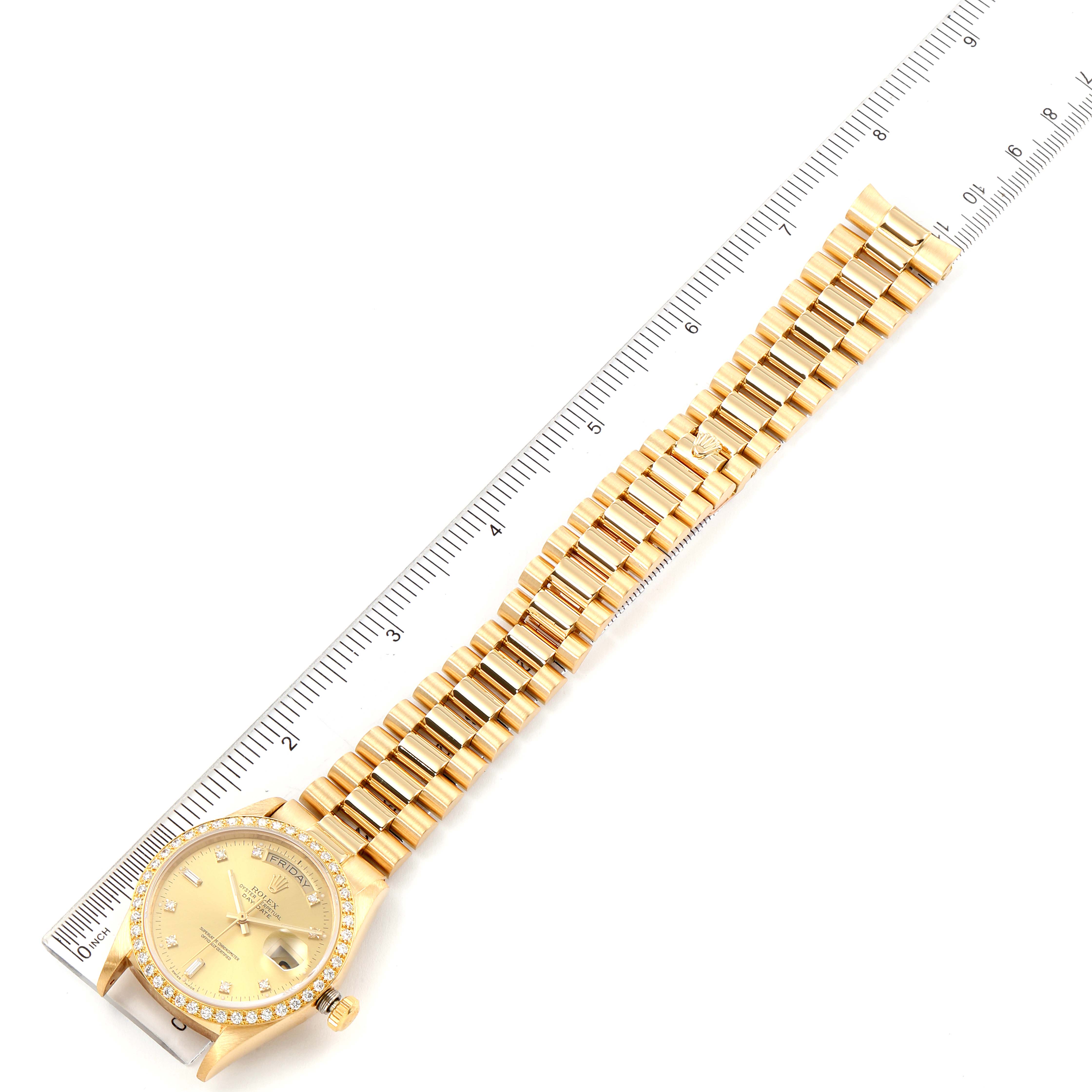 The Rolex President 18048 Men
s Yellow Gold Champagne Dial 18048 Men
s Yellow Gold Champagne Dial model watch is shown lying flat with the entire bracelet stretched next to a ruler for measurement.