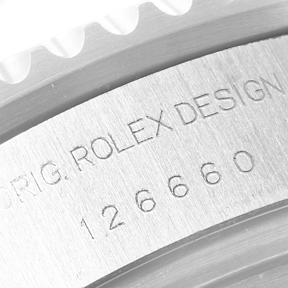 The image shows a close-up of the bezel and engraved case back of the Rolex Sea-Dweller 126660 Men
s Stainless Steel Black Dial 126660 Men
s Stainless Steel Black Dial watch.