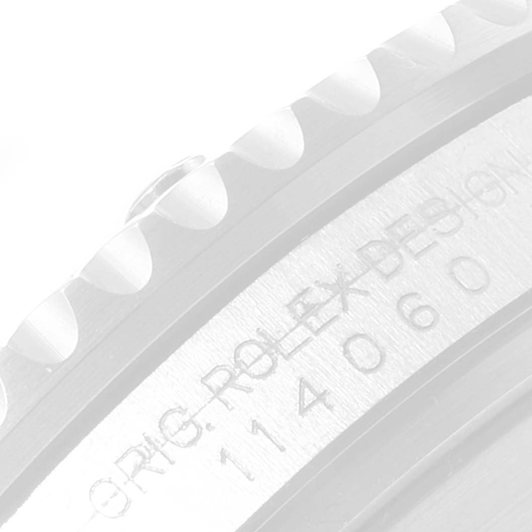 The image shows a close-up angle of the case side with engraved text and part of the bezel of a Rolex Submariner 114060 Men
s Stainless Steel Black Dial 114060 Men
s Stainless Steel Black Dial watch.