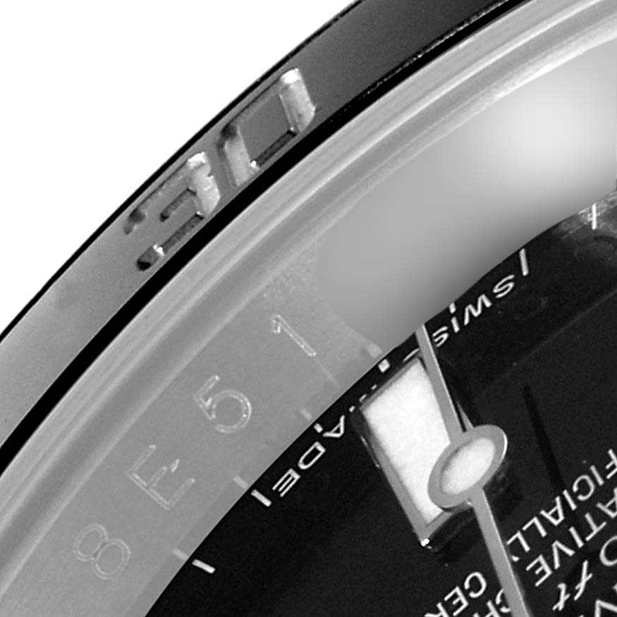 This close-up image of the Rolex Submariner 114060 Men
s Stainless Steel Black Dial 114060 Men
s Stainless Steel Black Dial shows the watch
s bezel, part of the dial, and a portion of the minute hand.