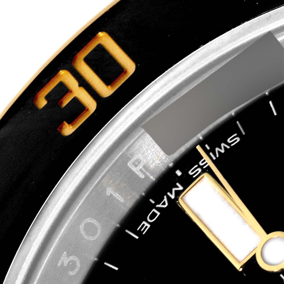 The image shows a close-up of the bezel and part of the dial of a Rolex Submariner 116613LN Men
s Steel and Gold (two tone) Black Dial 116613LN Men
s Steel and Gold (two tone) Black Dial watch.