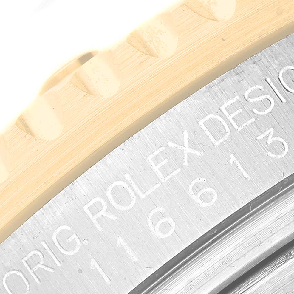 This image shows a close-up of the bezel and casing of the Rolex Submariner 116613LN Men
s Steel and Gold (two tone) Black Dial 116613LN Men
s Steel and Gold (two tone) Black Dial watch, highlighting the engraved model details.