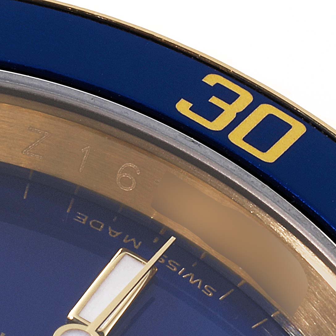 Close-up of the bezel and part of the dial, showing the 30-minute marker of the Rolex Submariner 16618 Men's Yellow Gold Blue Dial 16618 Men's Yellow Gold Blue Dial watch.