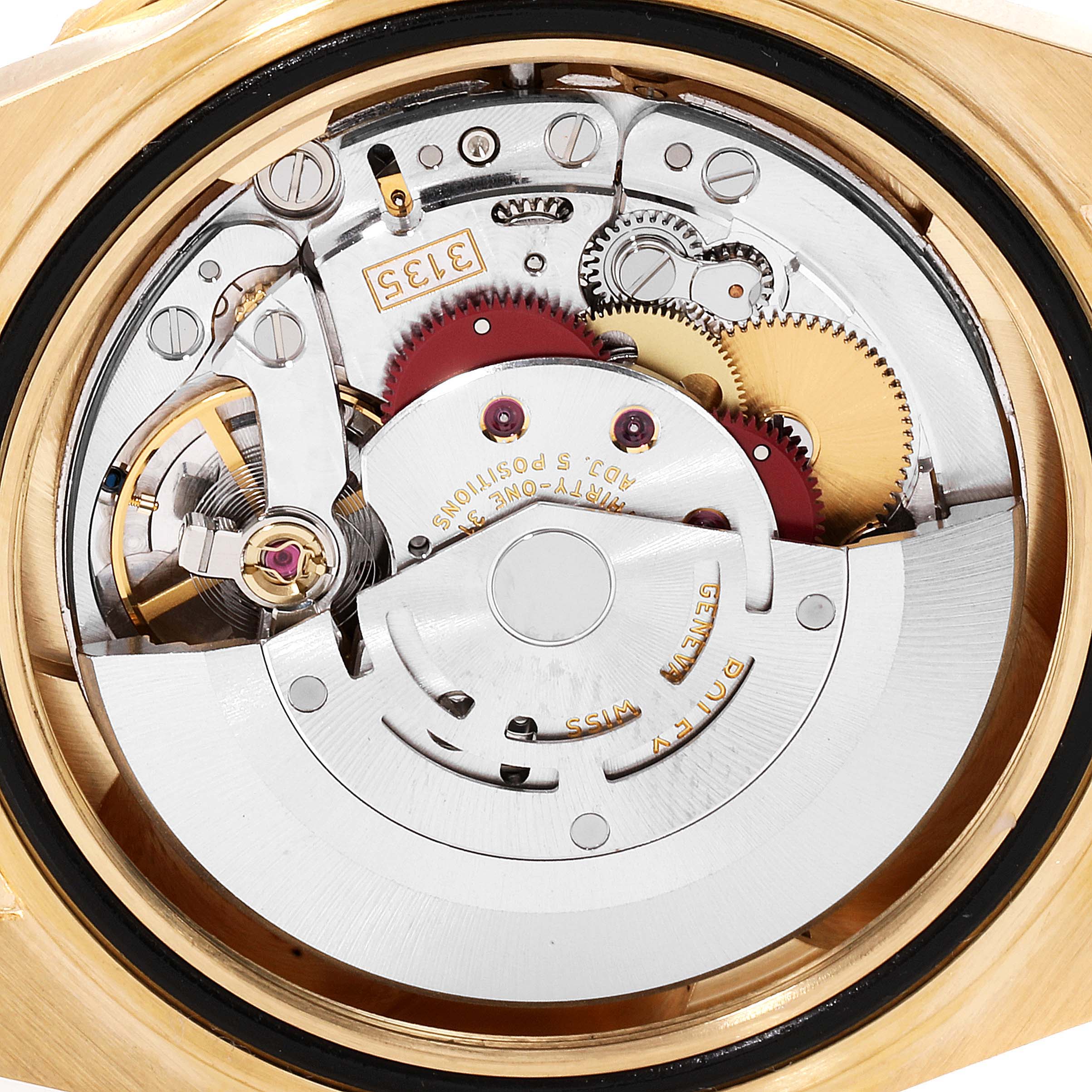 This is an internal view of the Rolex Submariner 16618 Men's Yellow Gold Blue Dial 16618 Men's Yellow Gold Blue Dial watch movement, showcasing gears, springs, and the intricate mechanics.