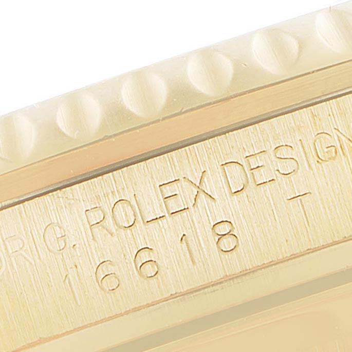 This close-up angle shows the engravings on the case of a Rolex Submariner 16618 Men's Yellow Gold Blue Dial 16618 Men's Yellow Gold Blue Dial model, displaying the model number 16618.