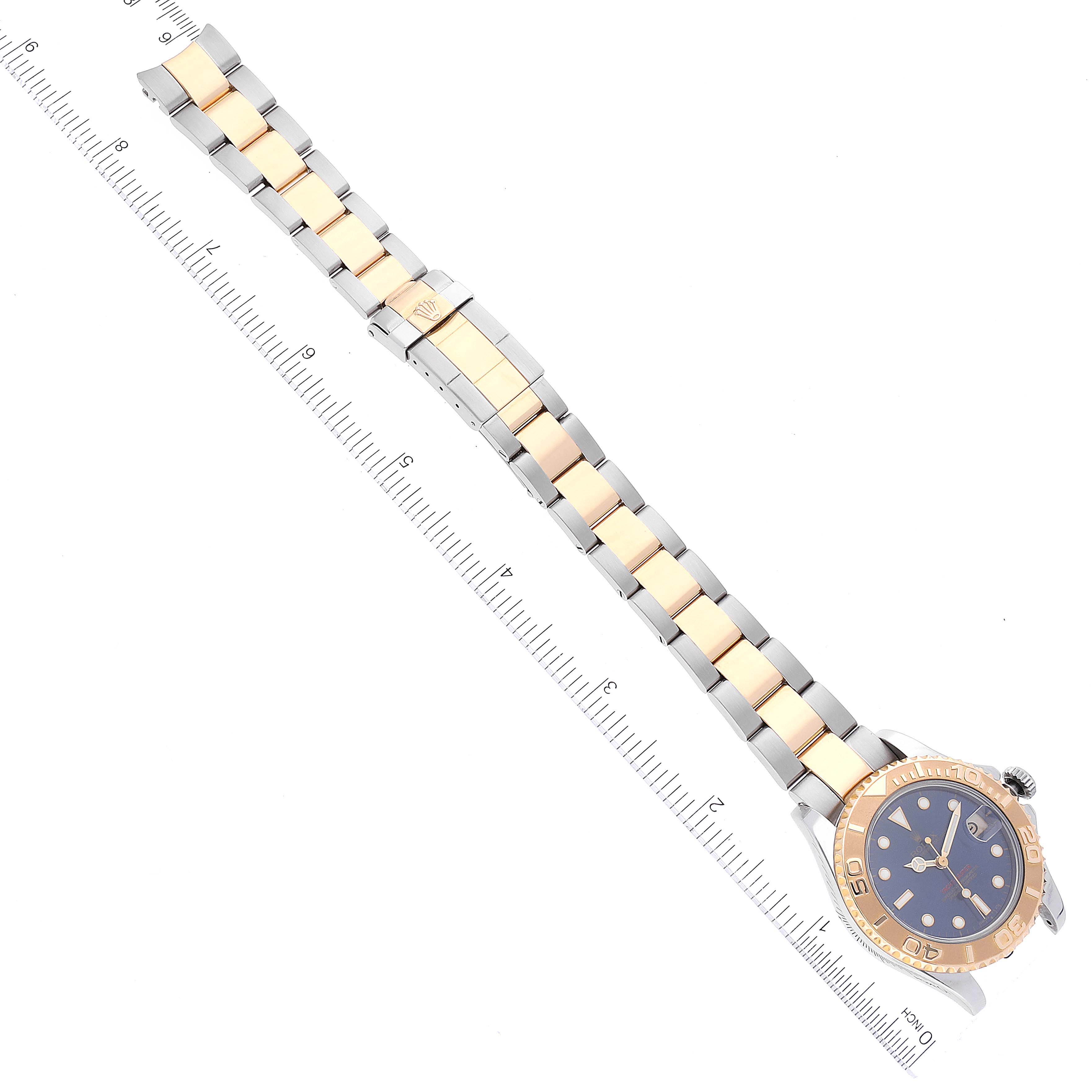 The image shows a Rolex Yacht-Master 68623 Men's Steel and Gold (two tone) Blue Dial 68623 Men's Steel and Gold (two tone) Blue Dial watch laid flat with a ruler beside it, displaying the face, bezel, and bracelet.