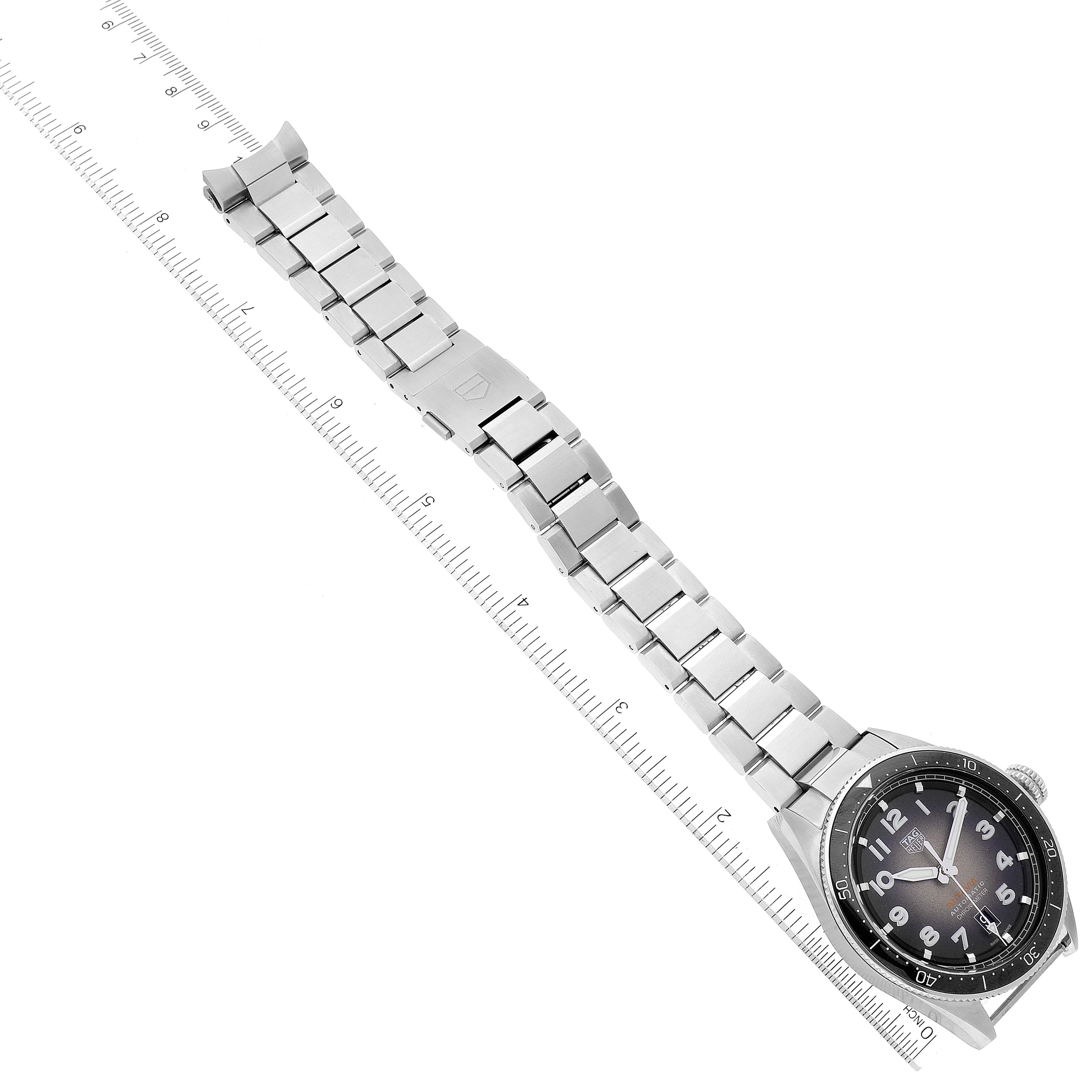 The image shows a Tag Heuer Autavia WBE5114.EB0173 Men's Stainless Steel Brown Dial WBE5114.EB0173 Men's Stainless Steel Brown Dial watch laid flat with a metal bracelet and a ruler measuring the length.
