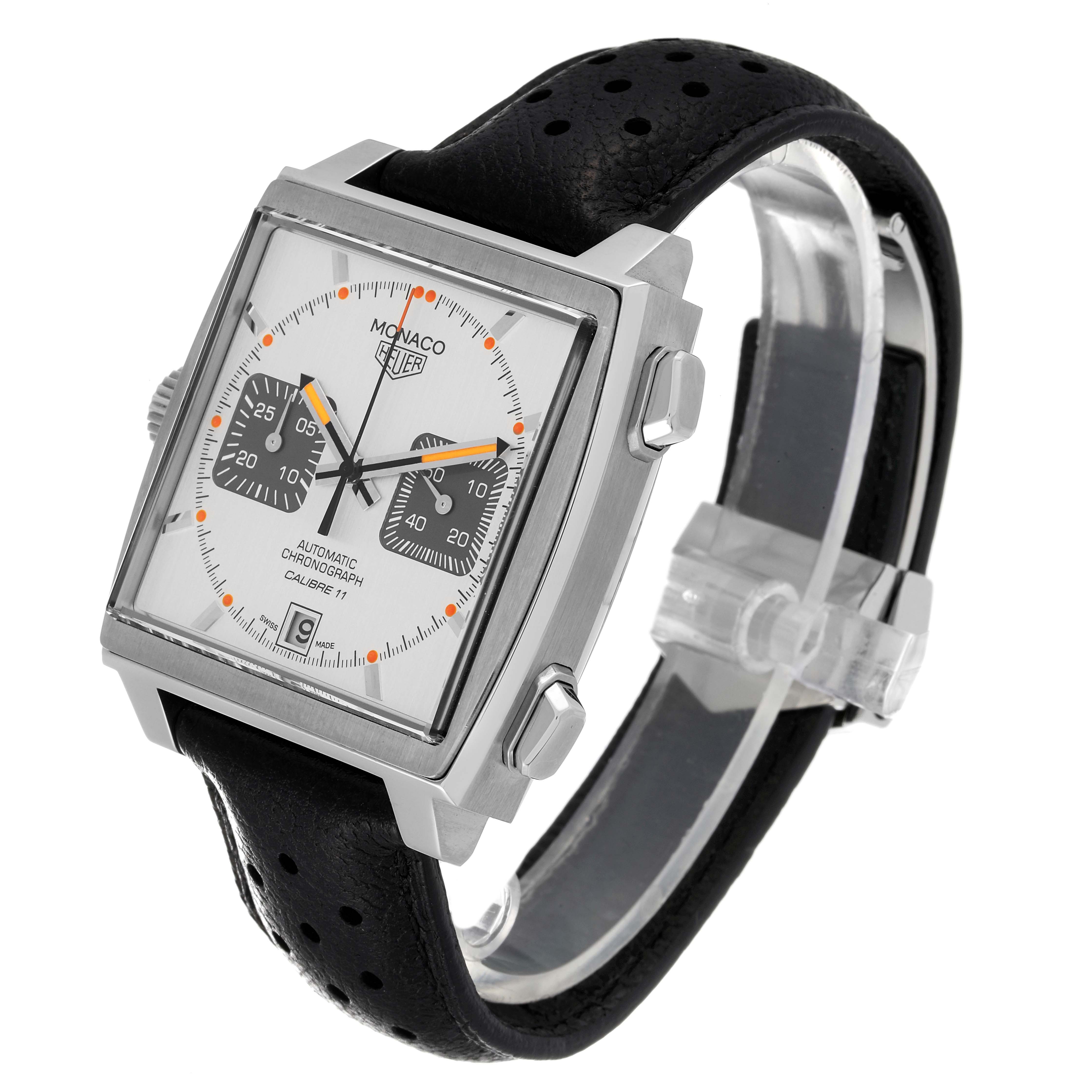 The Tag Heuer Monaco watch is shown at an angle revealing the square face, chronograph dials, and black perforated leather strap.