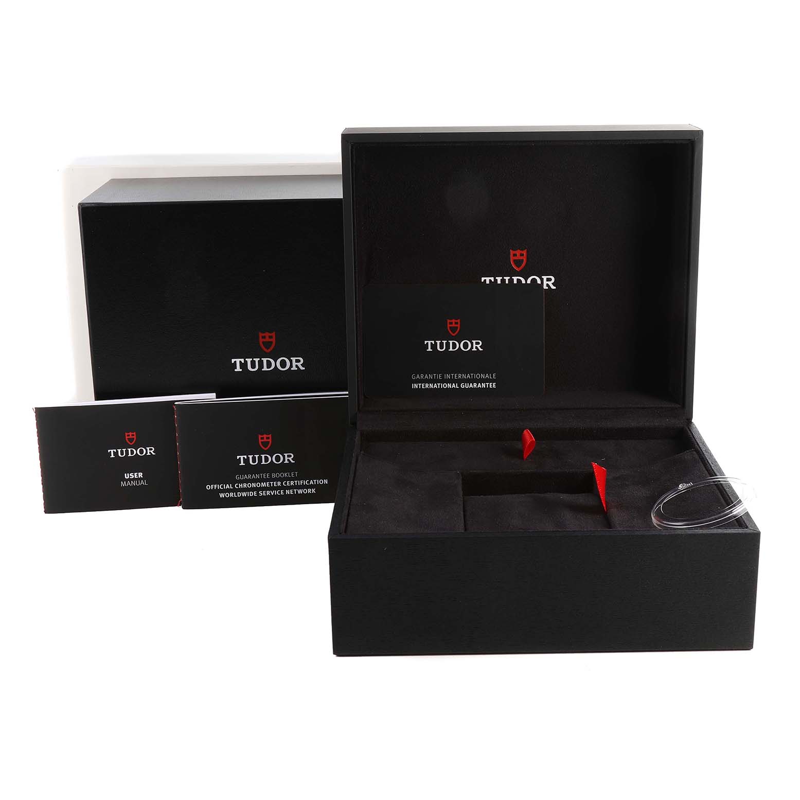 This image shows the Heritage Black Bay by Tudor packaging, including the box, user manual, and warranty card.