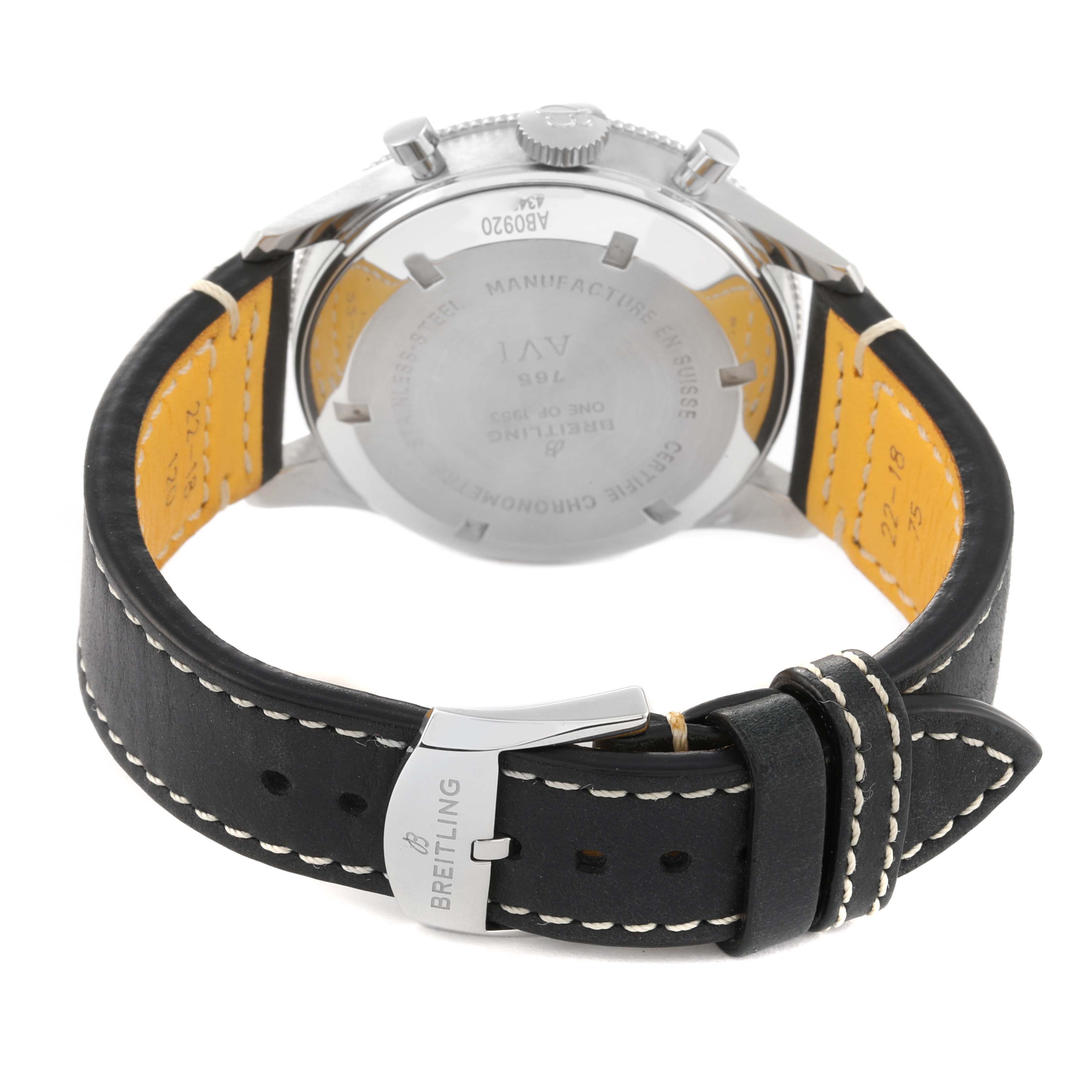 The image shows the back view of a Breitling Navitimer watch, highlighting its case back, leather strap, and branded buckle.