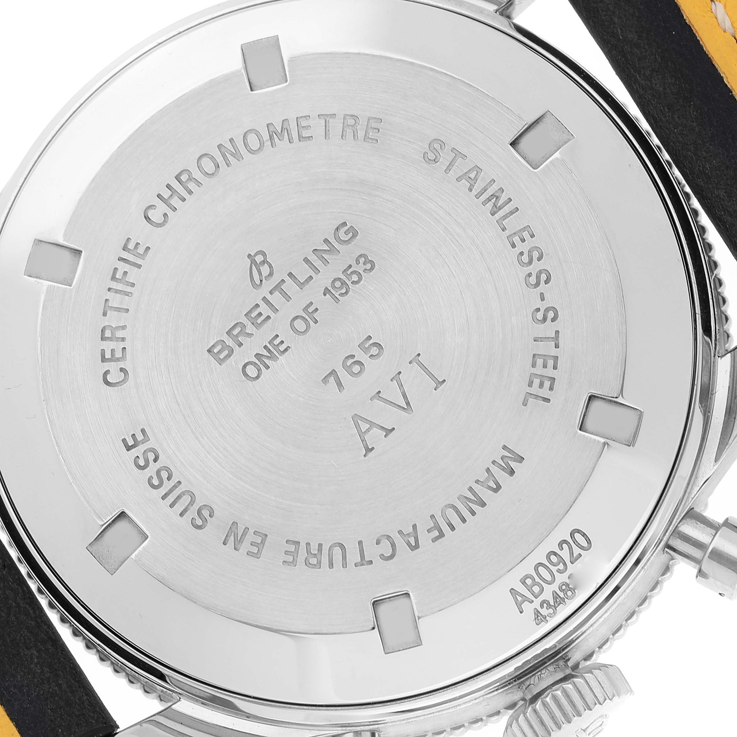 The image shows the case back of a Breitling Navitimer model, highlighting engravings and the strap attachment points.