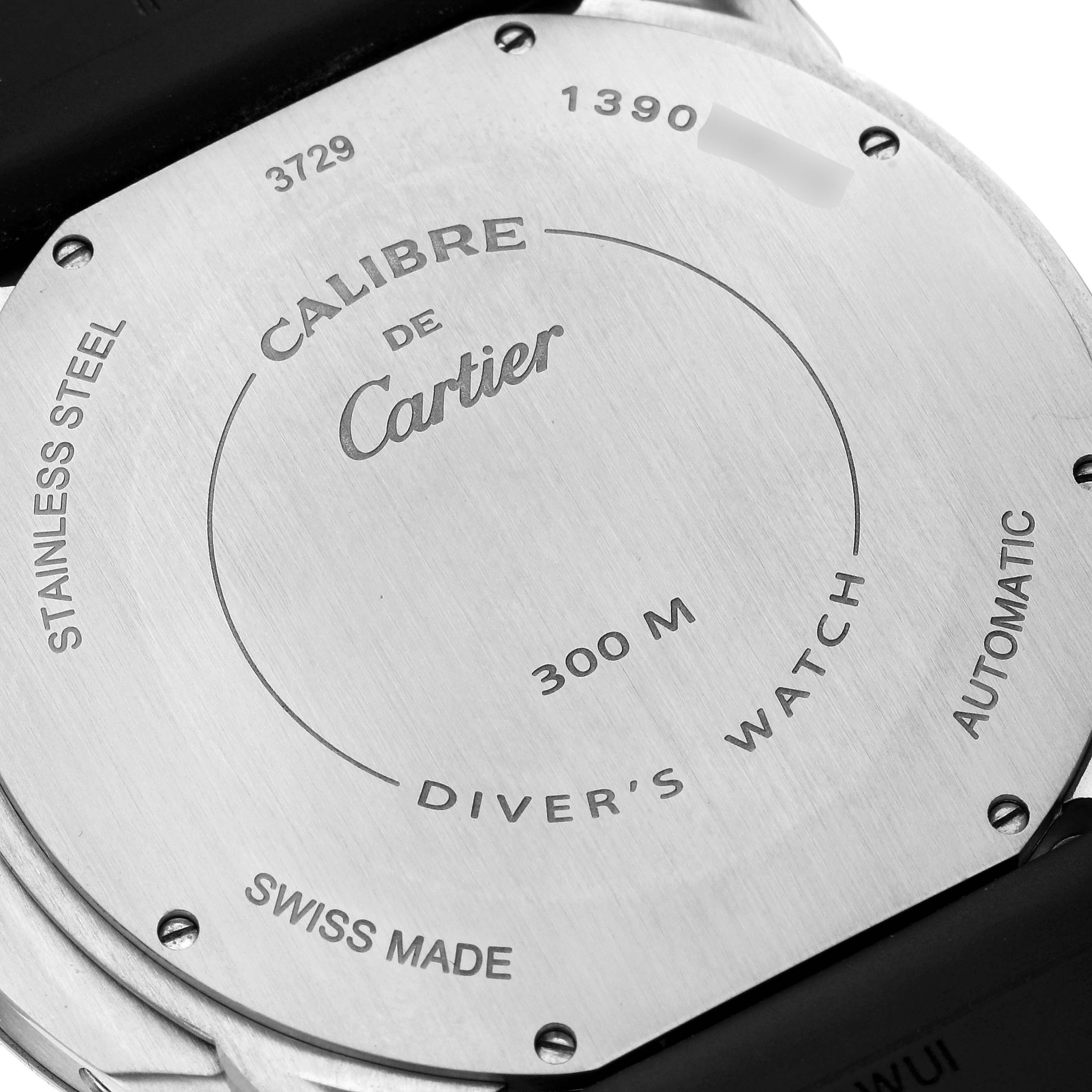 The image shows the back of a Calibre de Cartier watch by Cartier, including engravings and specifications.