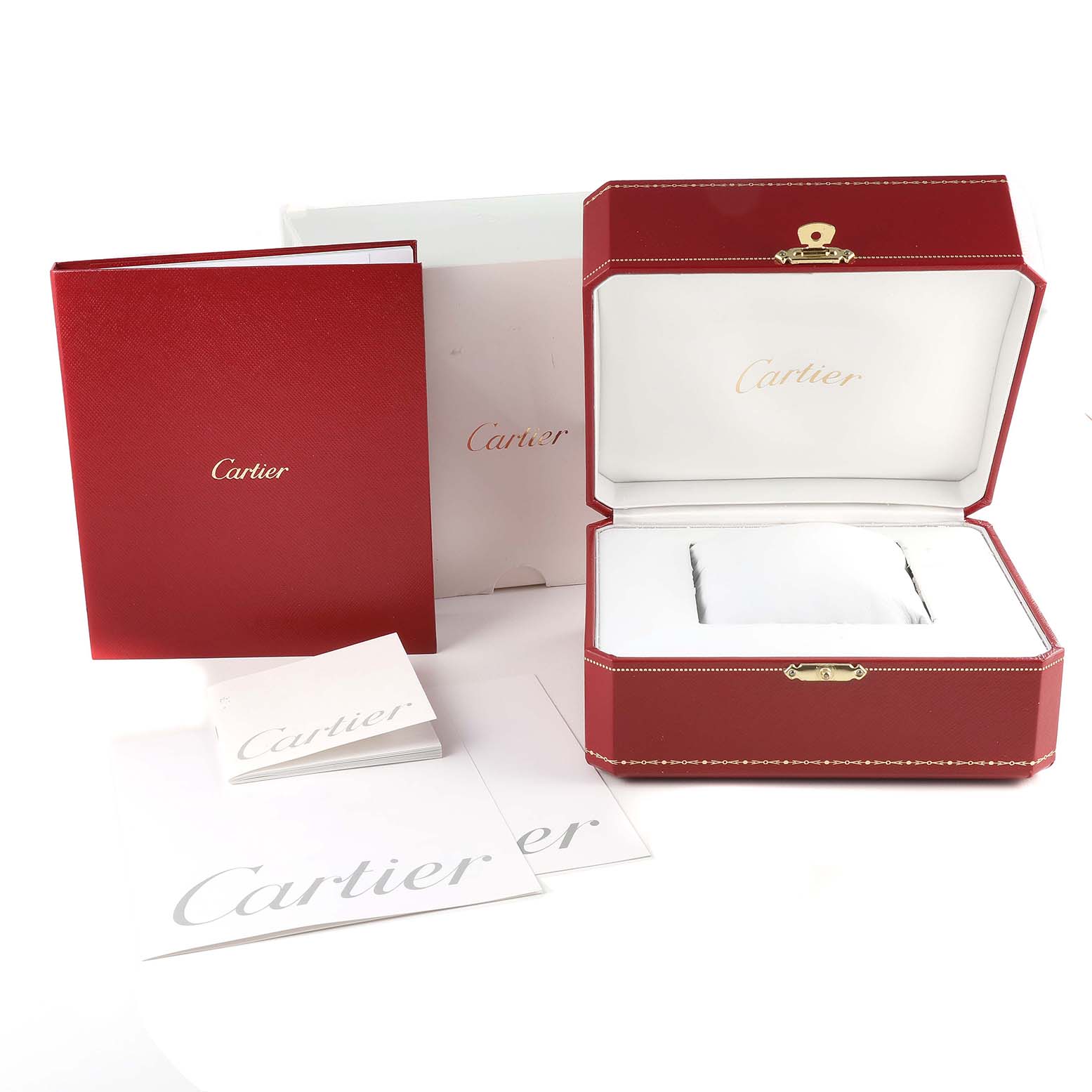 The image shows the branded red box and packaging for the Calibre de Cartier watch by Cartier, along with accompanying documents.