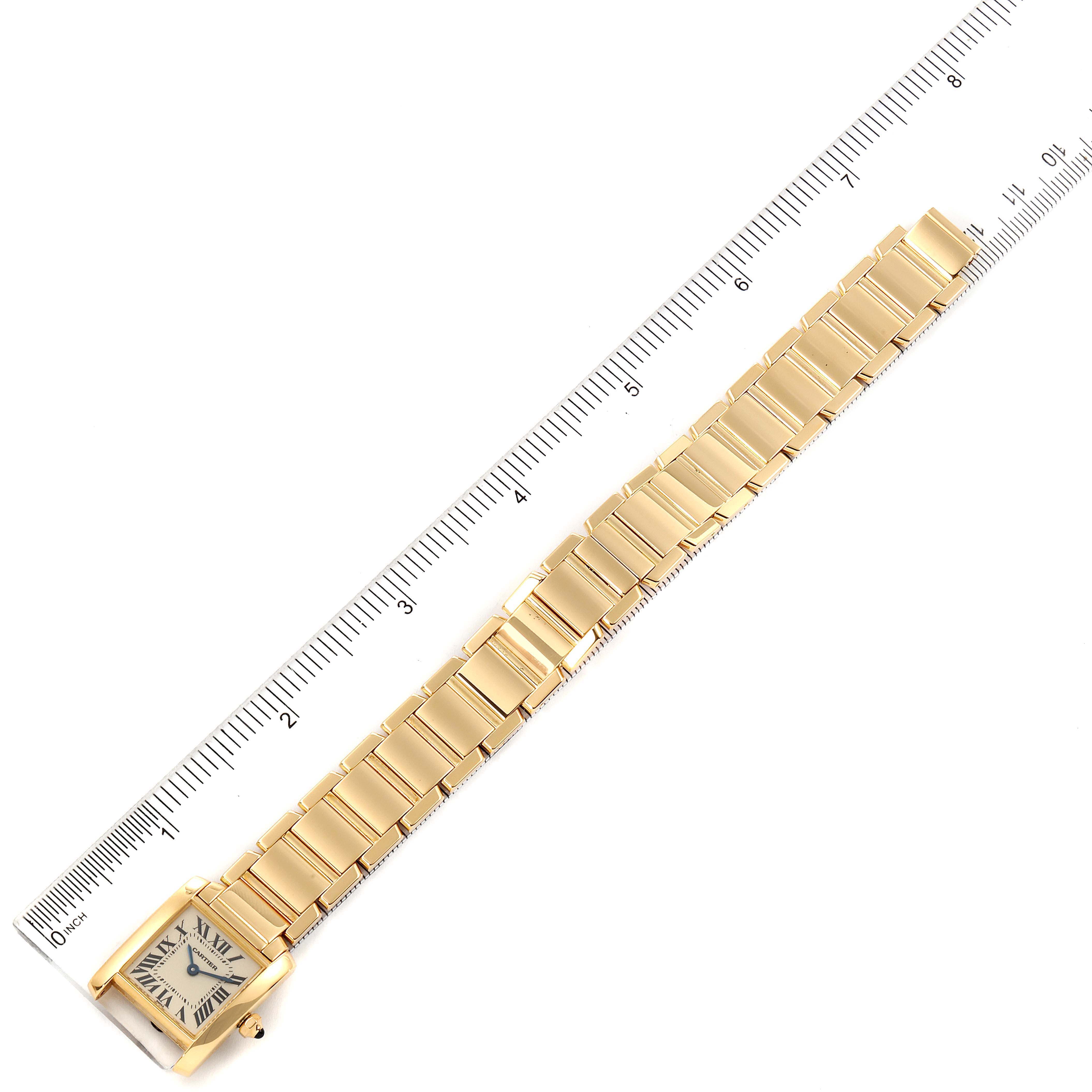 The image shows a flat view of a Cartier Tank Française watch, displaying its face and entire bracelet alongside a ruler for scale.